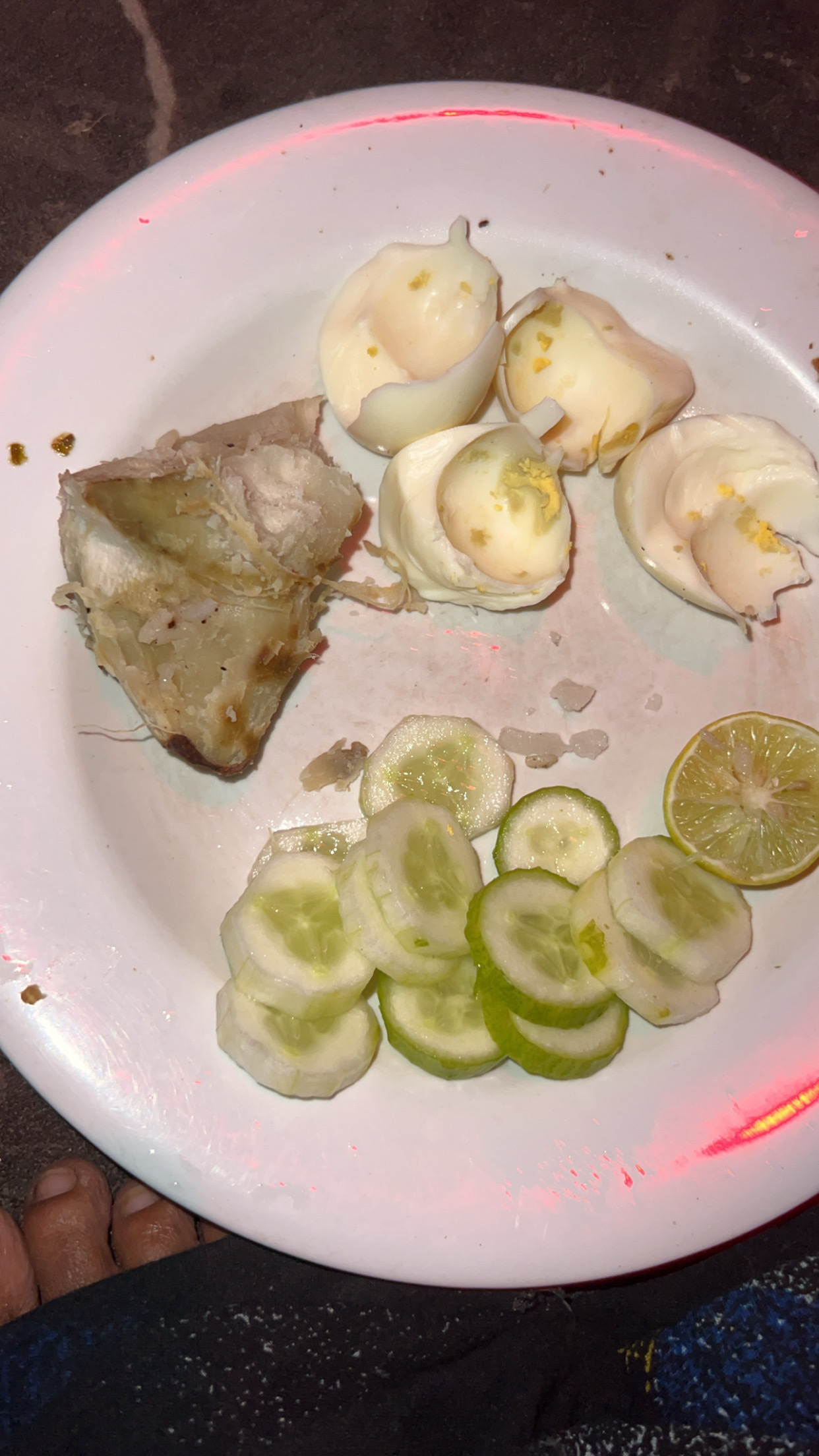 A plate containing boiled eggs, cucumber slices, and a piece of boiled yam, offering a balanced mix of protein, carbs, and minimal fats.