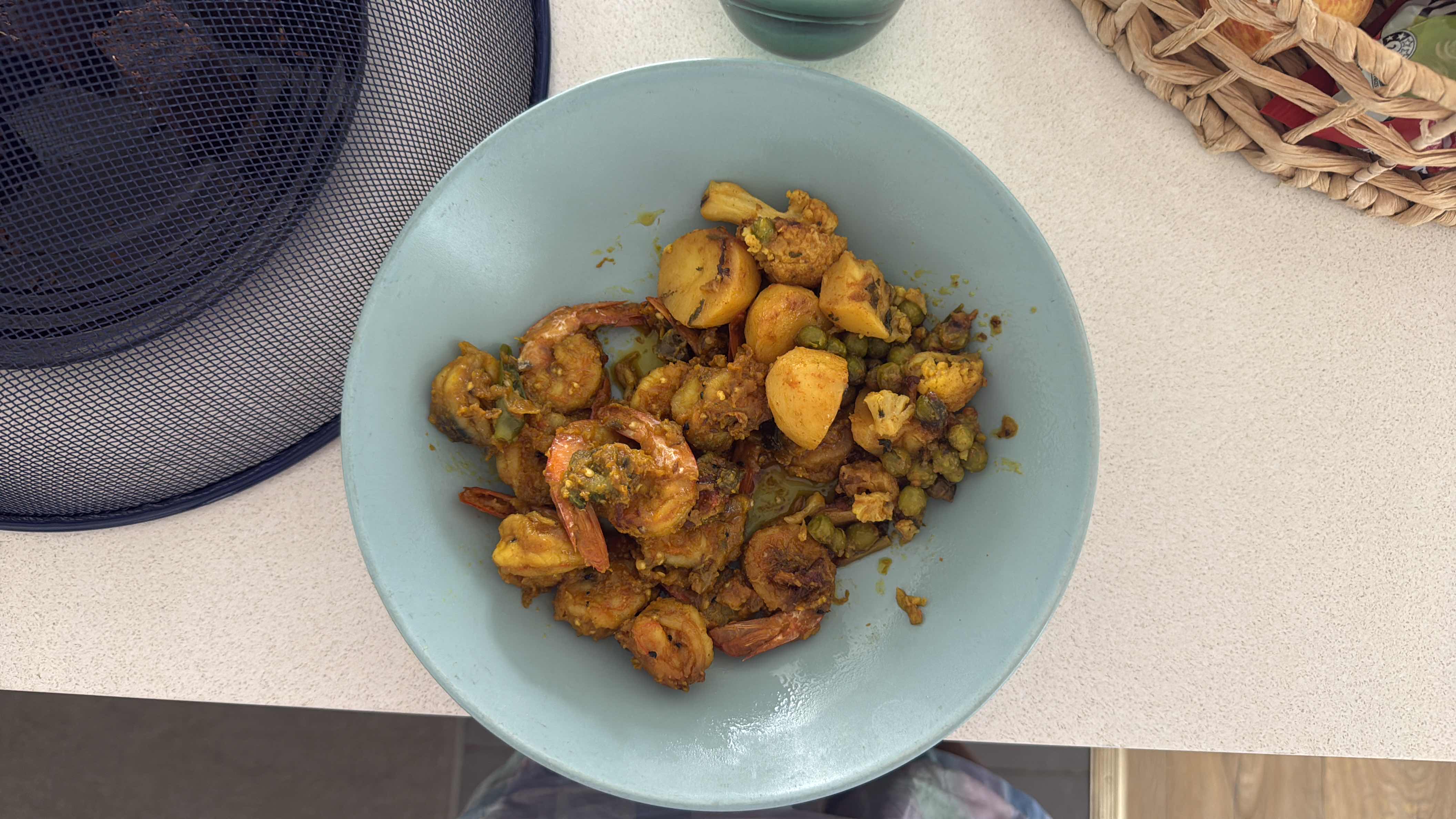 A nutritious dish containing shrimp, potatoes, peas, and cauliflower, cooked with spices.