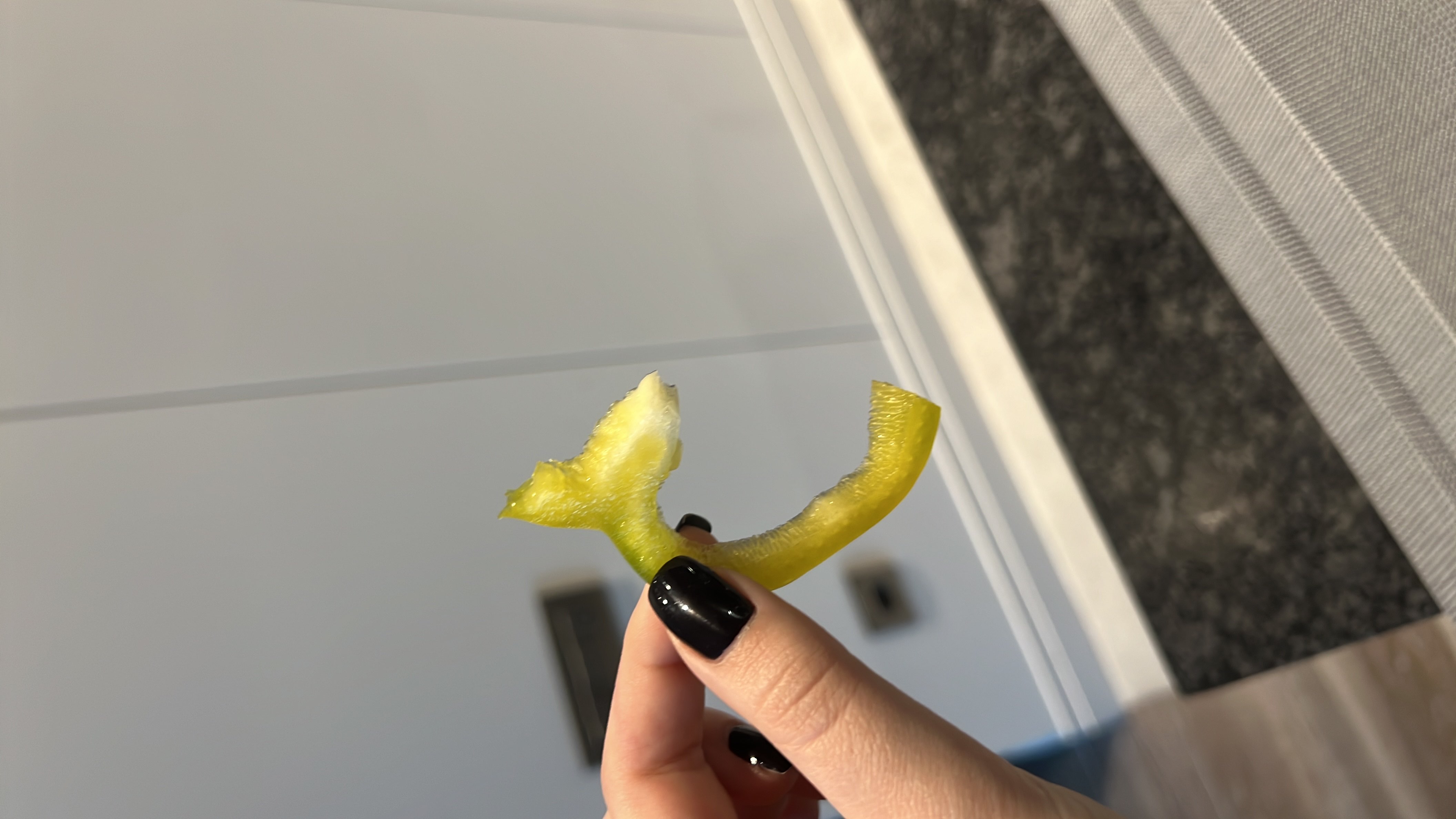 A single slice of green bell pepper, low in calories and rich in vitamins, suitable for a healthy snack.