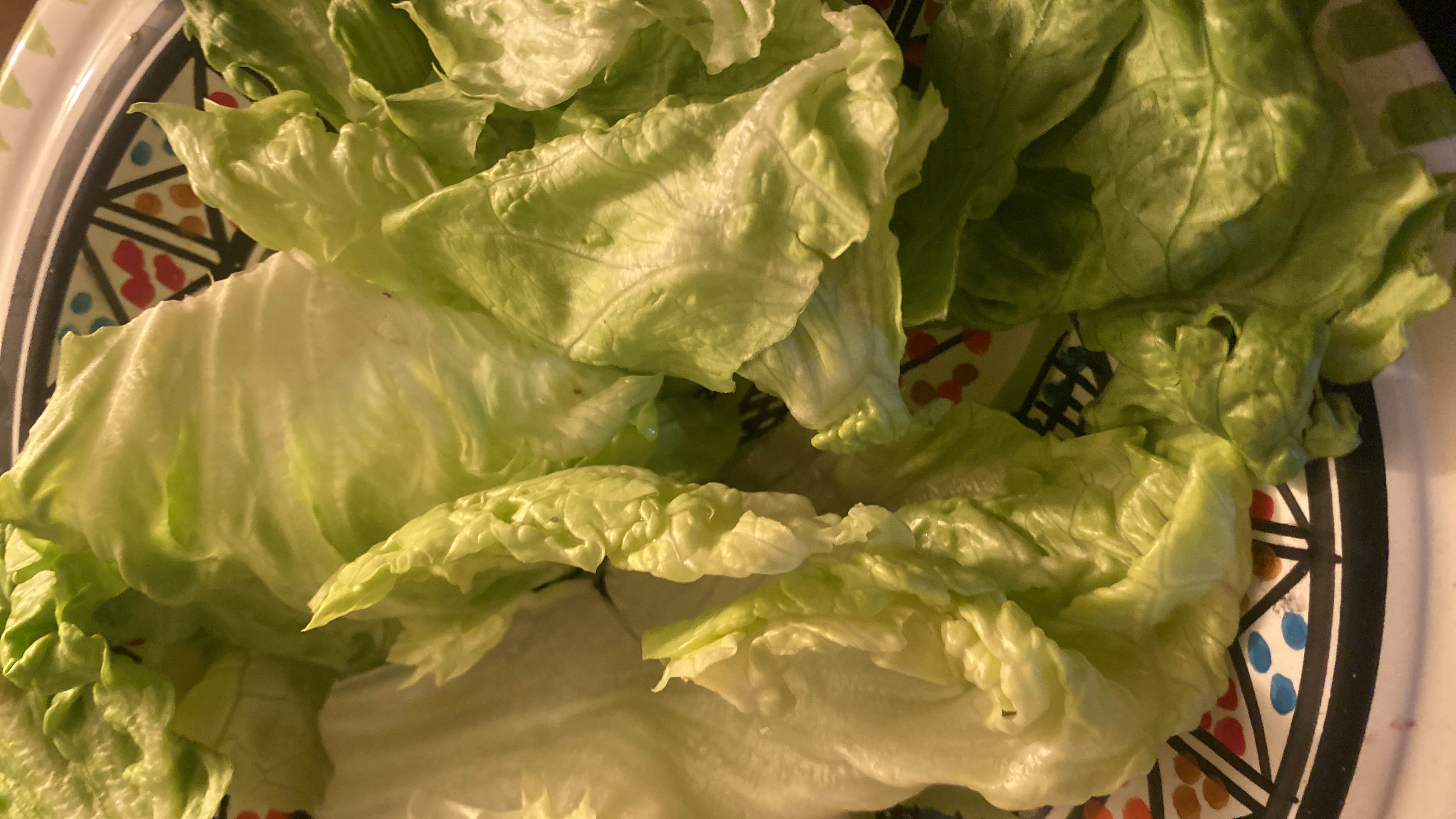 The image shows fresh lettuce leaves, which are low in calories and rich in nutrients, making them a healthy choice.