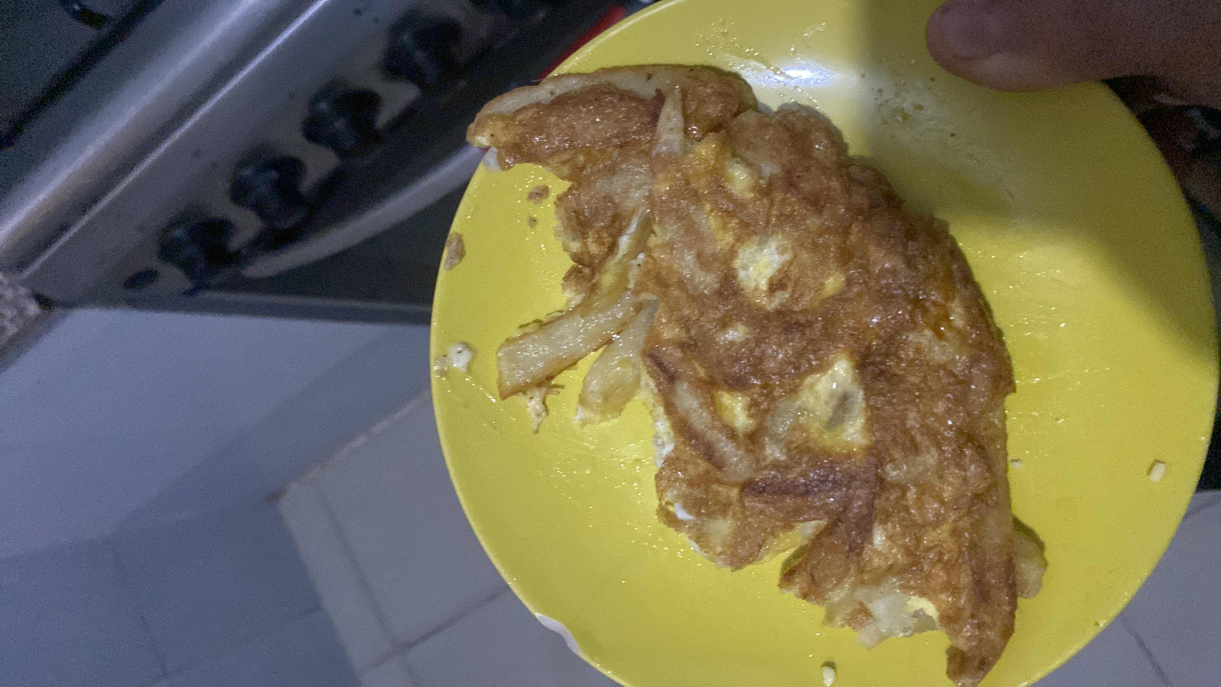 A homemade omelette with fried potatoes, likely cooked with oil, providing a balanced mix of protein, fats, and carbohydrates.
