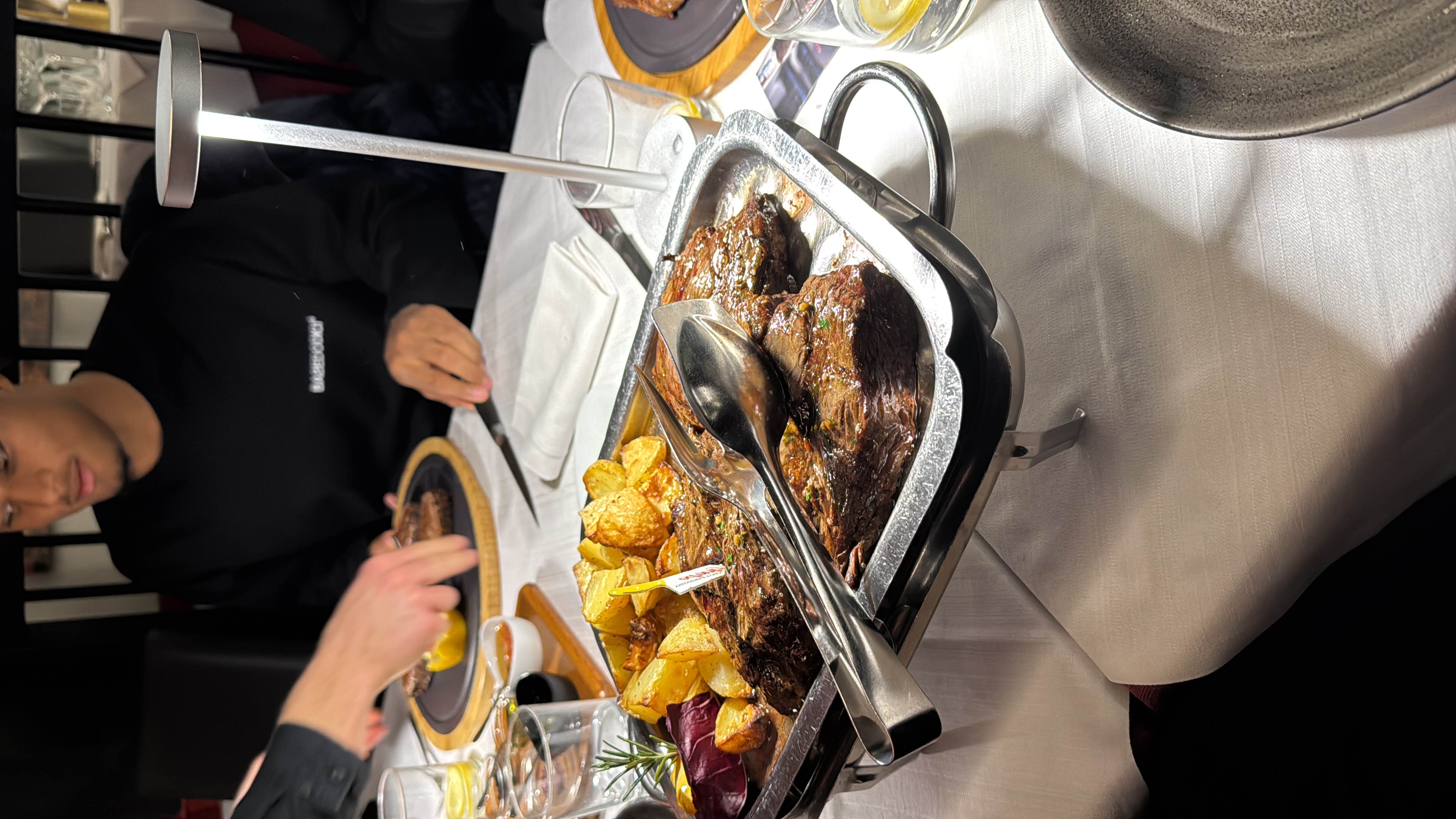 A hearty meal featuring grilled steak with roasted potatoes, served in a restaurant setting.