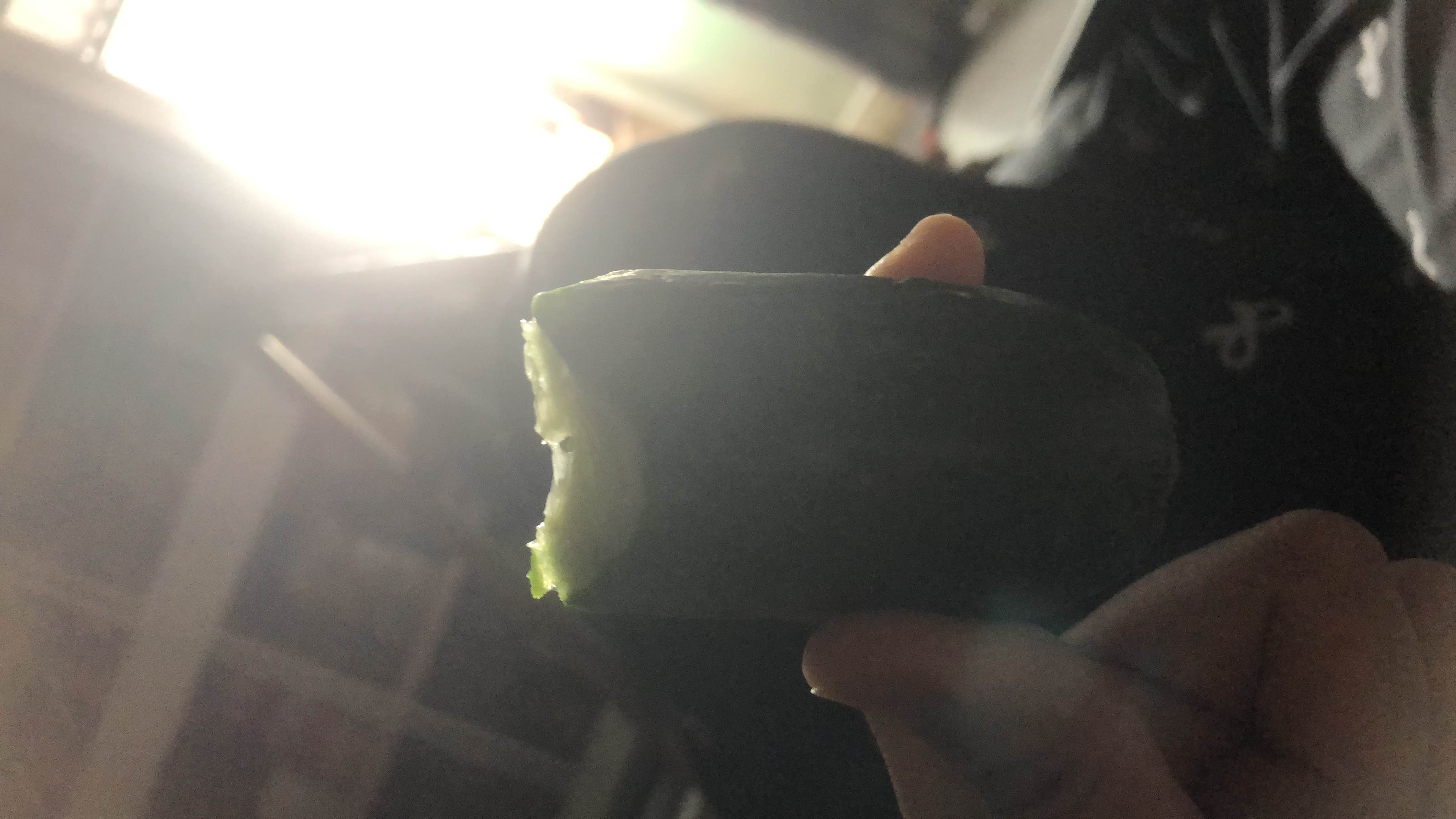 A fresh cucumber, which is low in calories and rich in hydration, making it a healthy snack option.