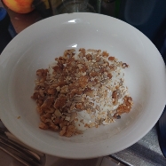 A nutritious bowl of oats with walnuts and milk, providing a balanced mix of protein, carbs, and healthy fats.