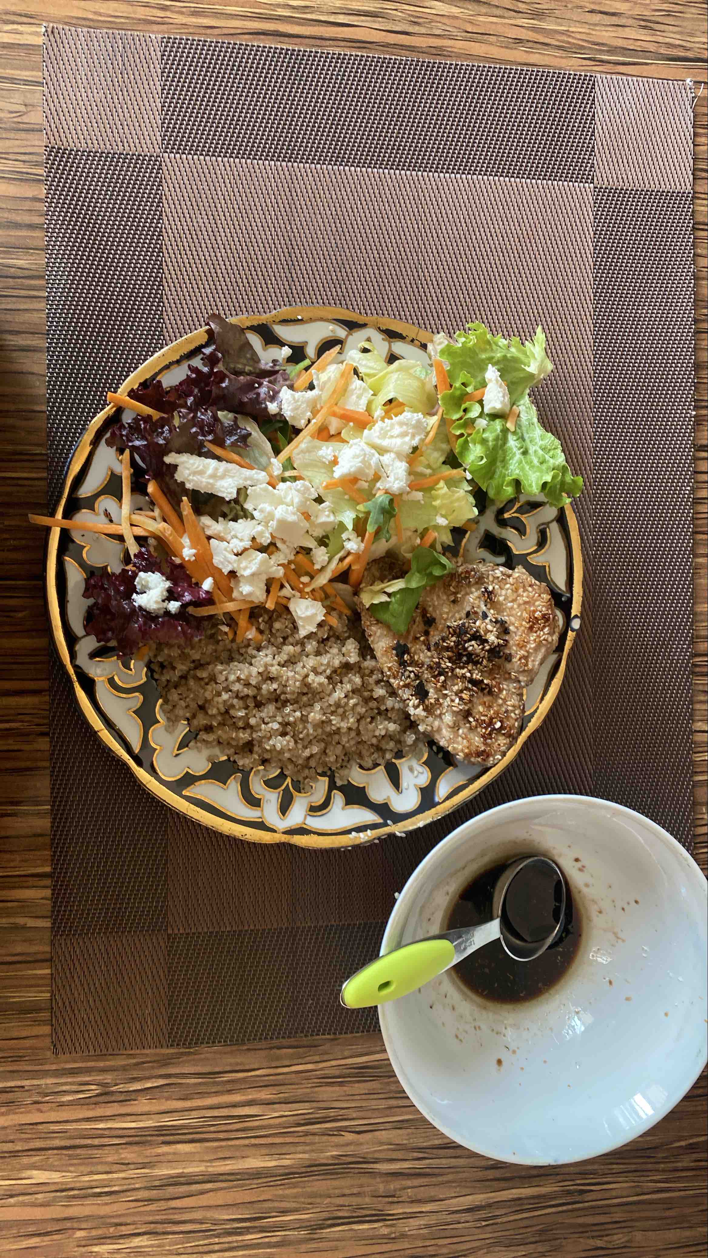 A nutritious tuna meal consisting of quinoa, tuna, mixed greens, carrots, feta cheese, and sesame seeds, providing a balanced intake of protein, carbs, and healthy fats.
