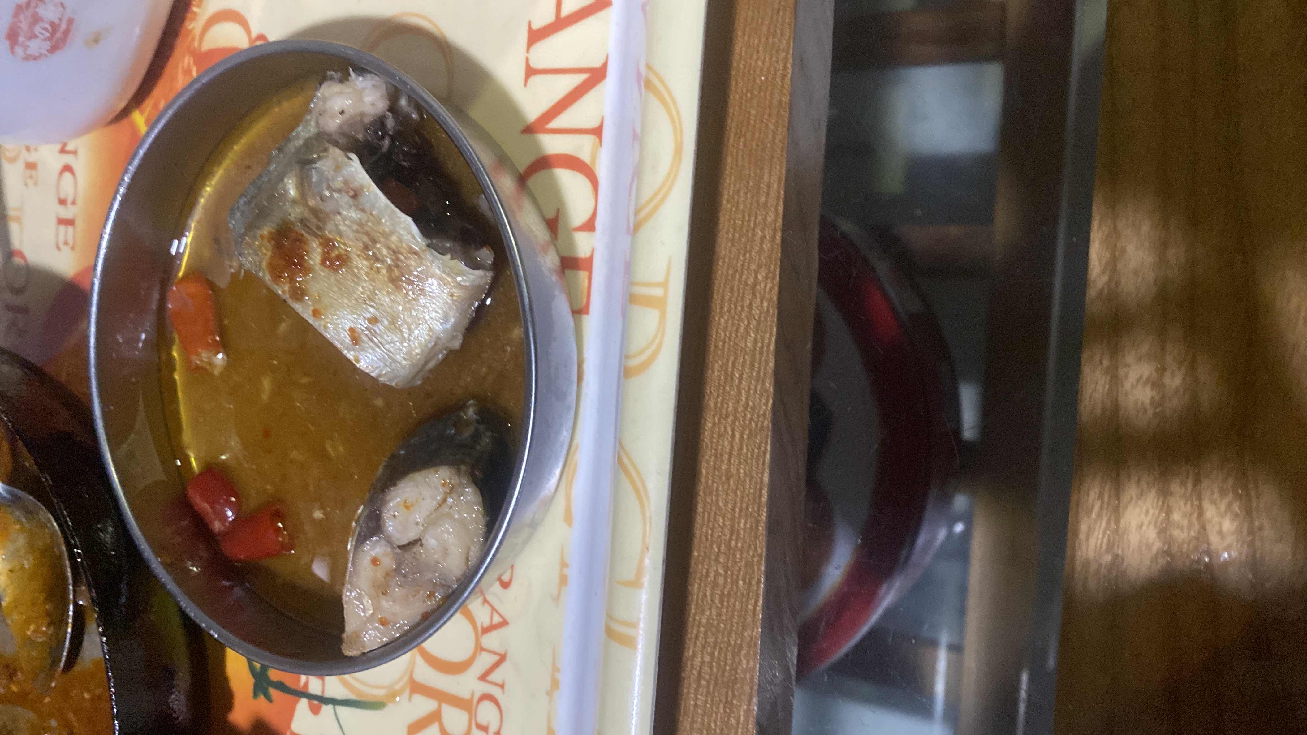 A dish featuring fish in a savory sauce with chili peppers, providing a high-protein and moderately low-carb meal.