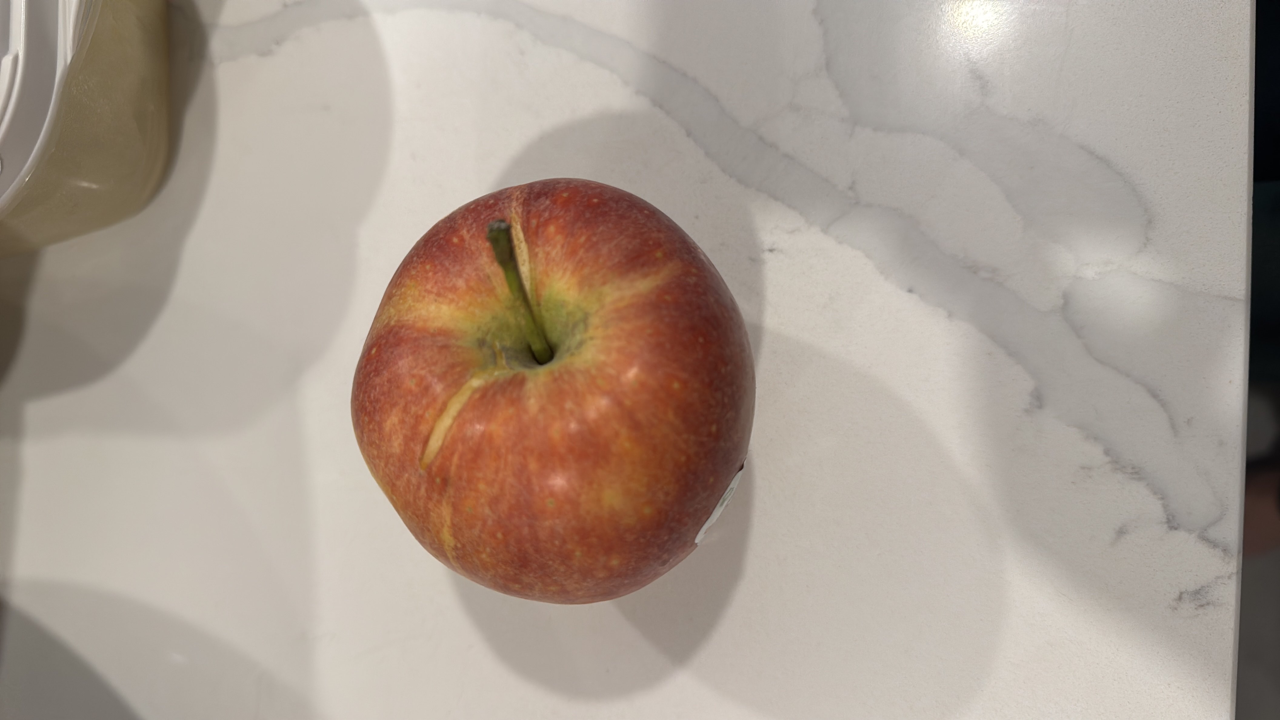 A fresh apple, which is a nutritious fruit rich in fiber and vitamins, providing a healthy snack option.