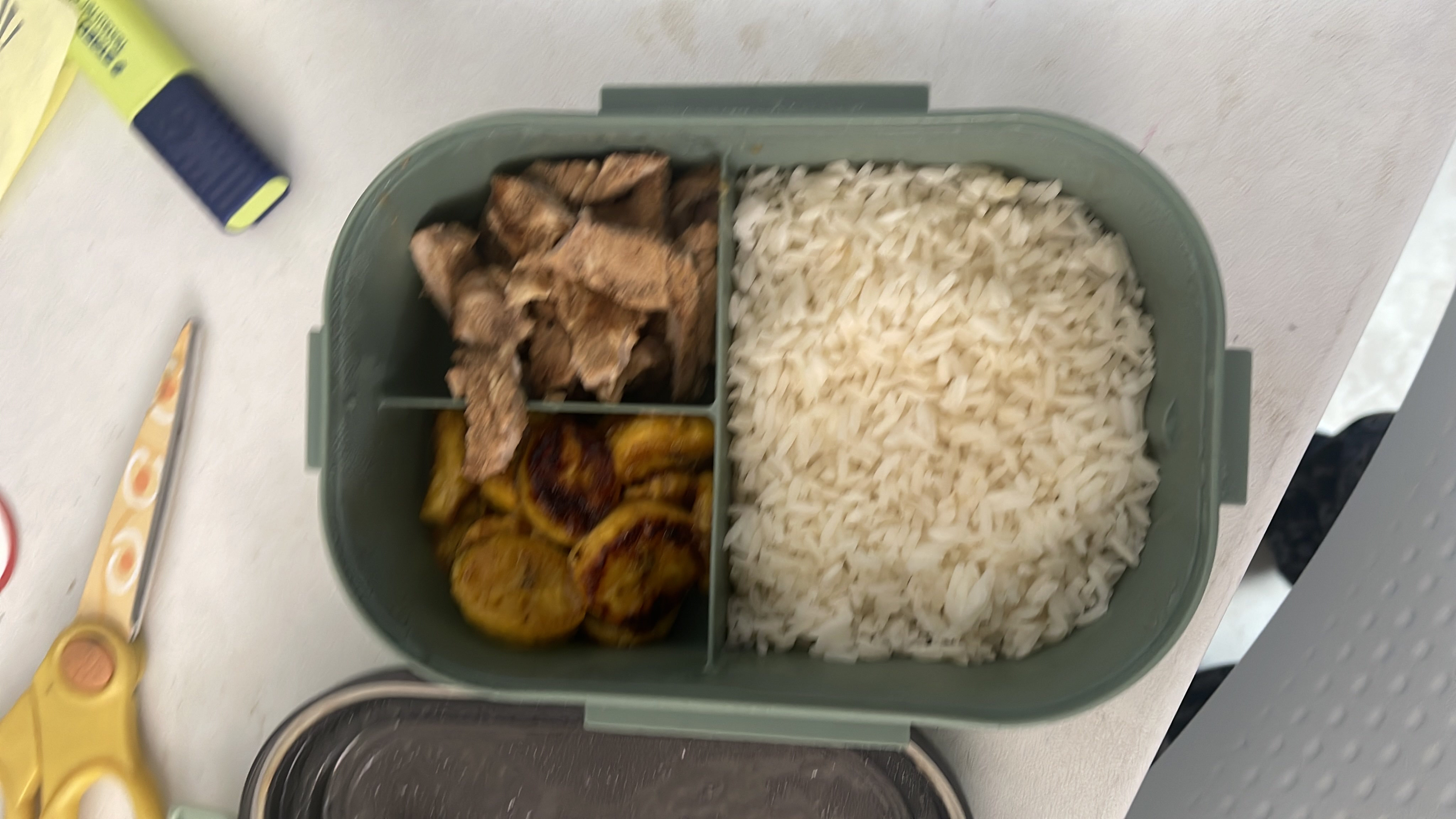 A balanced meal consisting of white rice, grilled beef, and fried plantains, providing a good mix of carbohydrates, protein, and fats.