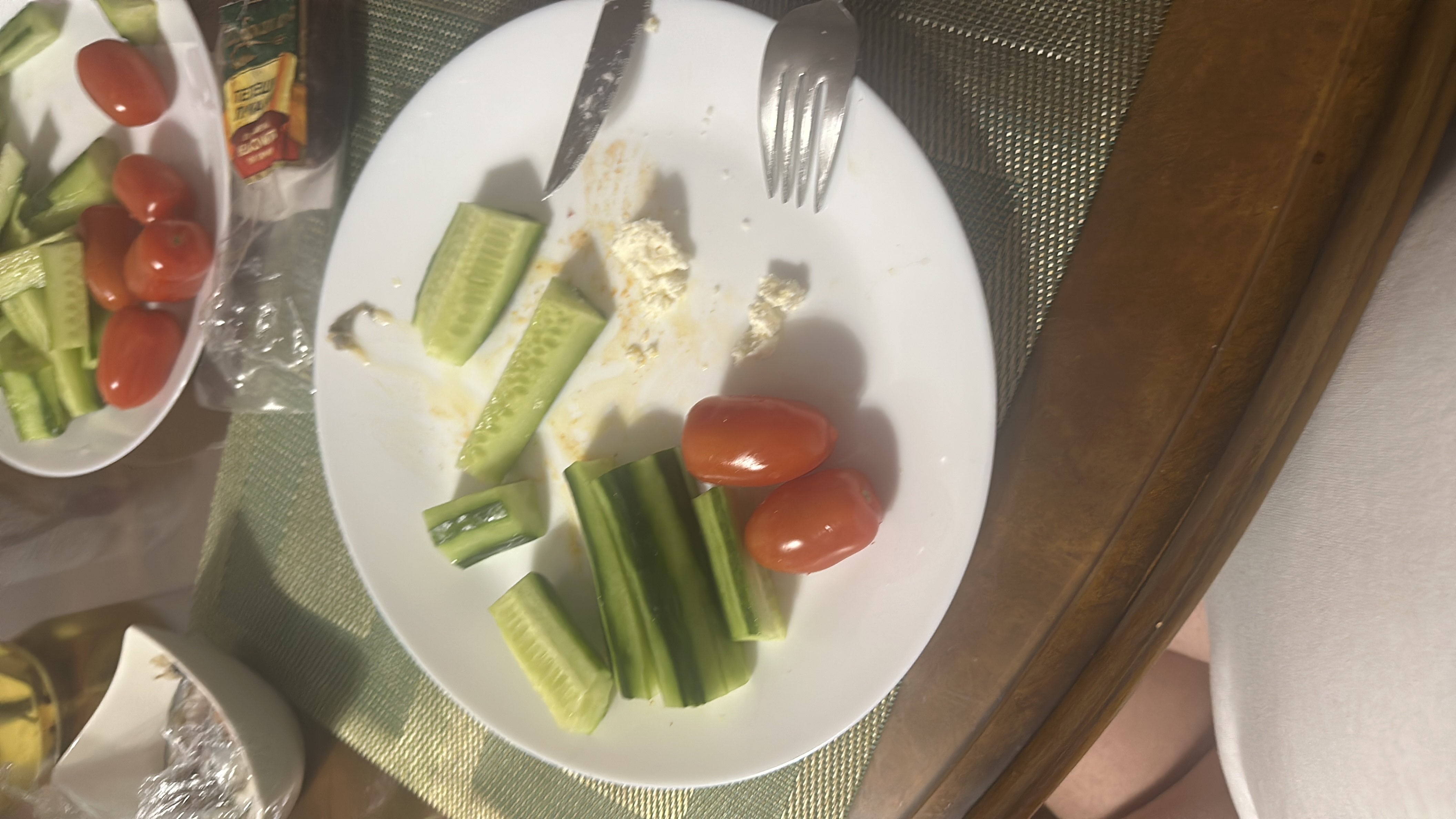 A light meal consisting of cucumber slices, cherry tomatoes, and a small portion of cheese, providing a low-calorie and nutritious option.