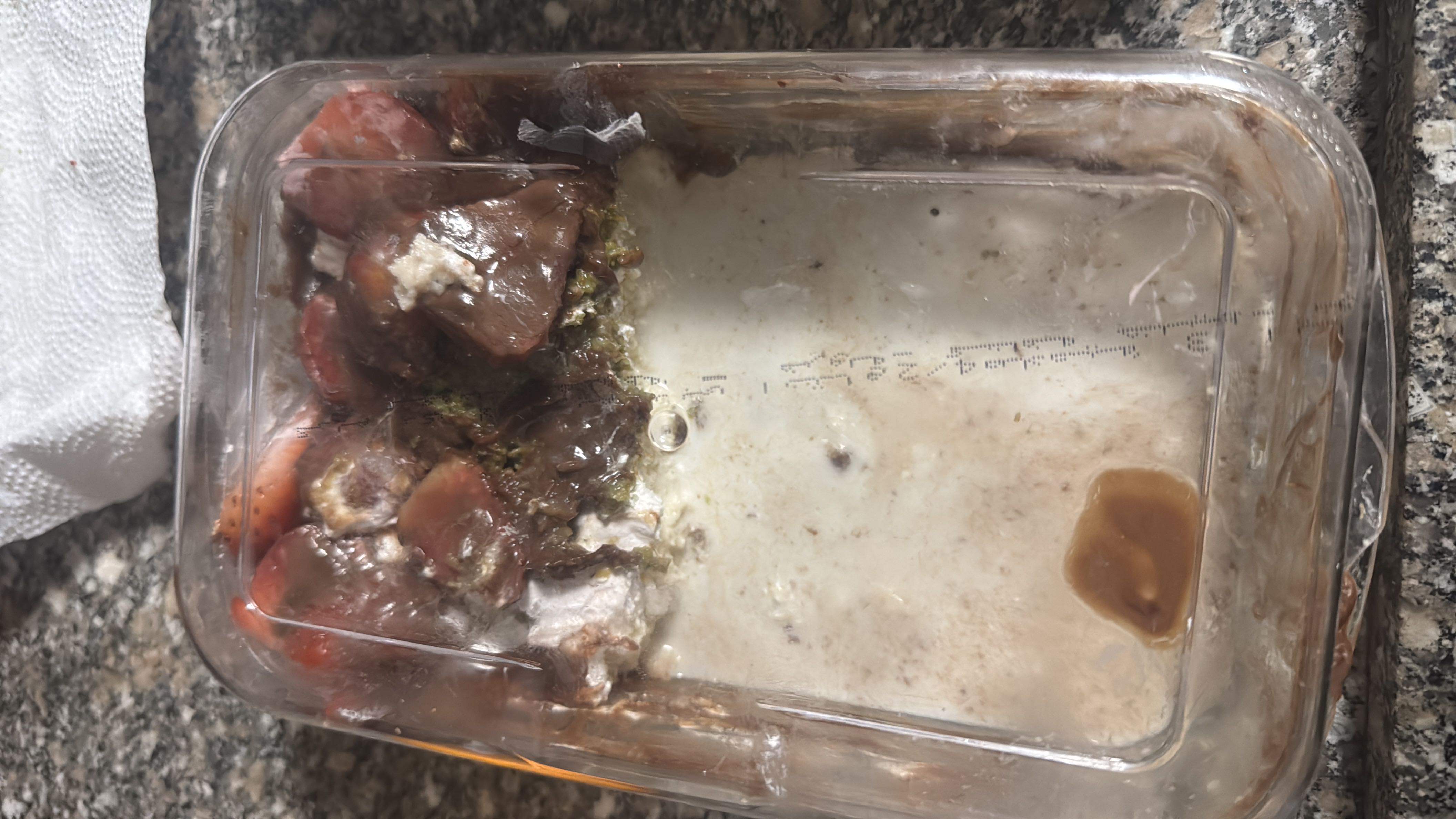 The image shows a spoiled or decomposed food item in a container, making it unsuitable for consumption or nutritional analysis.