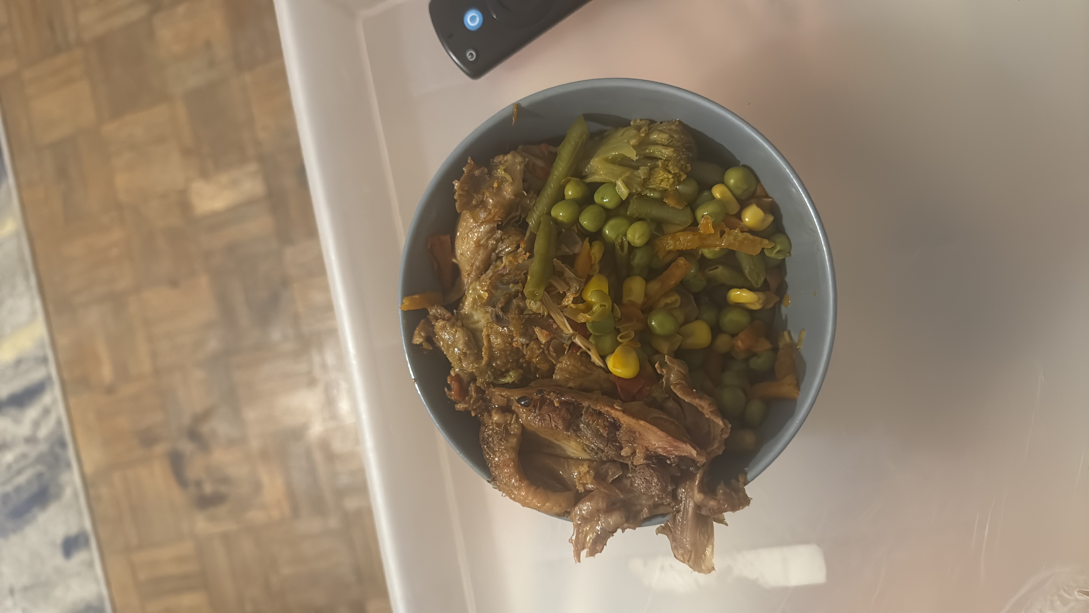 A nutritious meal consisting of shredded chicken and mixed vegetables, including green peas, corn, green beans, and broccoli.