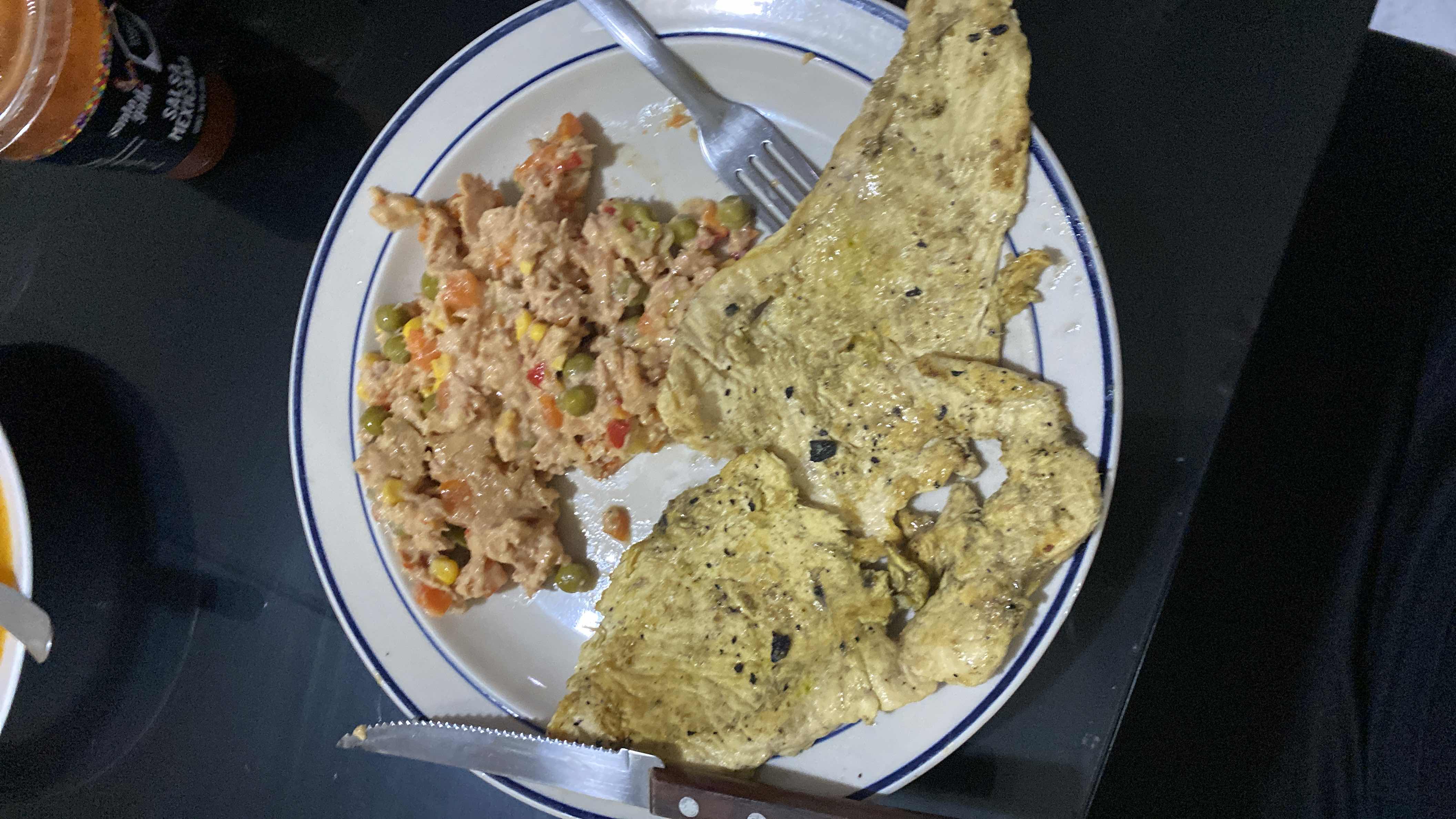 A protein-rich meal consisting of grilled chicken and a tuna mix with vegetables, providing a balanced intake of protein, carbs, and fats.