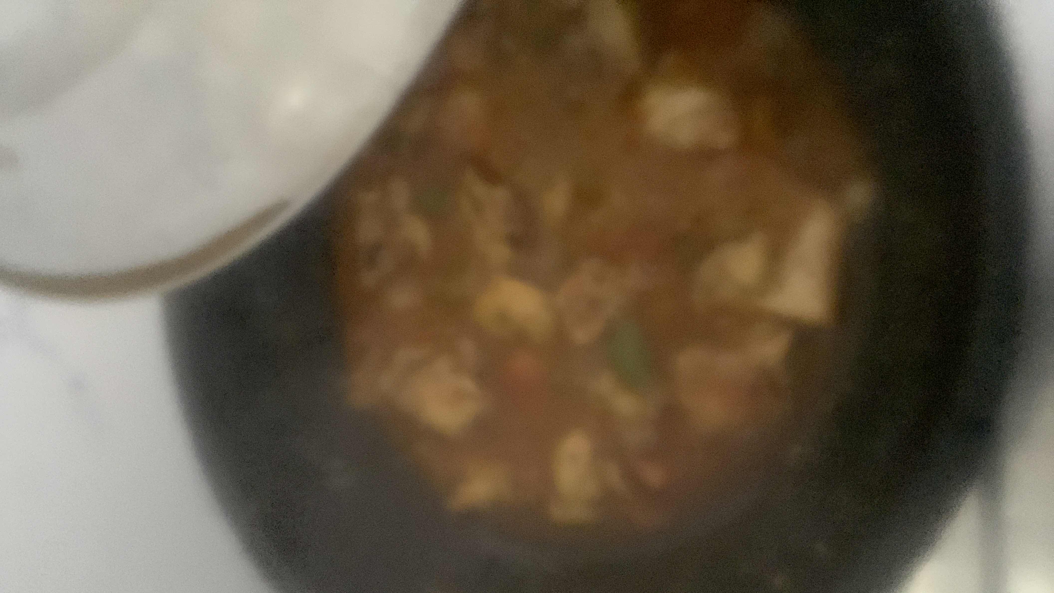 A homemade chicken and vegetable curry with a rich, flavorful gravy, providing a balanced mix of protein, carbs, and fats.