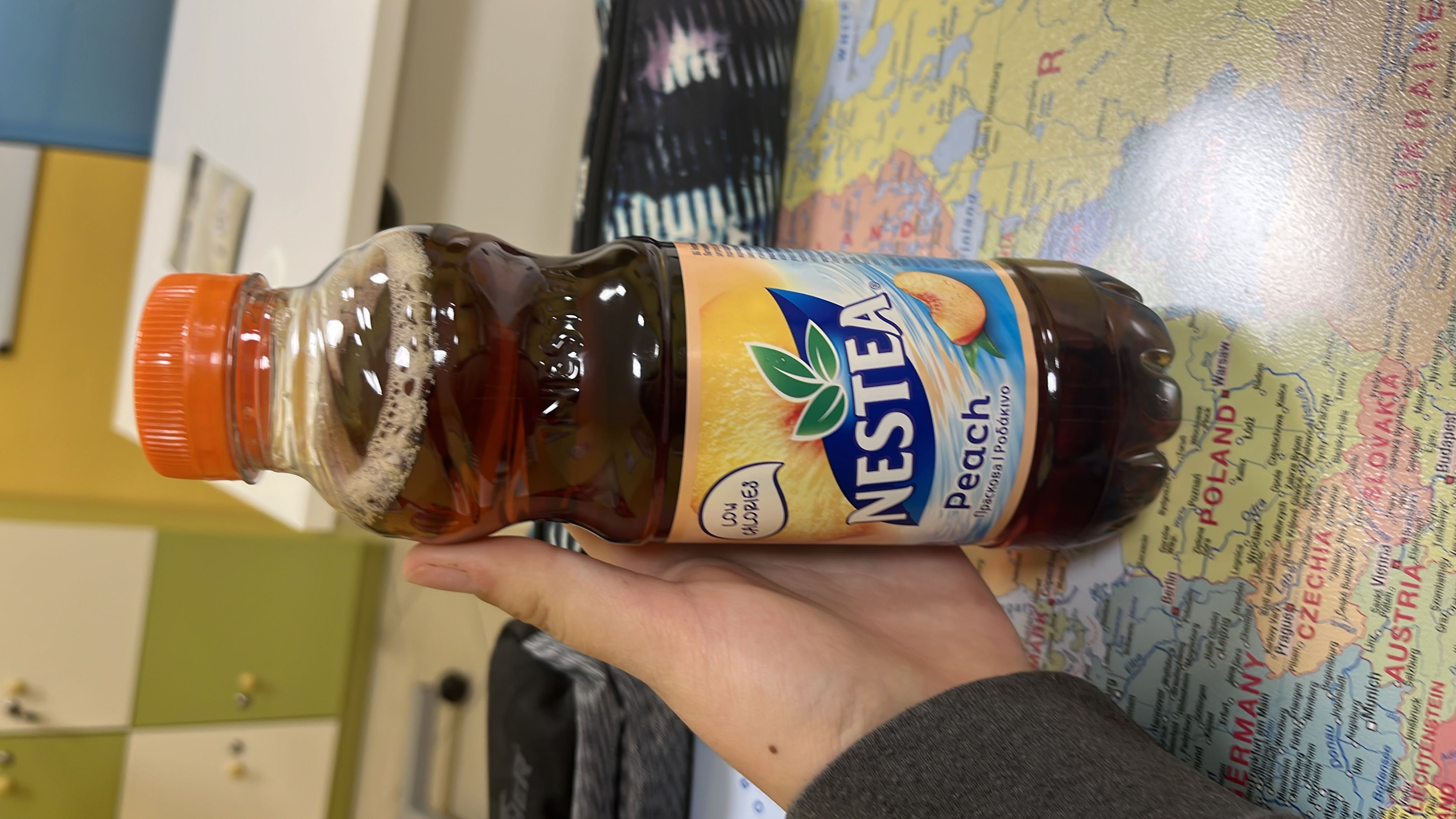 Nestea Peach is a low-calorie iced tea beverage with a refreshing peach flavor, containing black tea extract and sweeteners.
