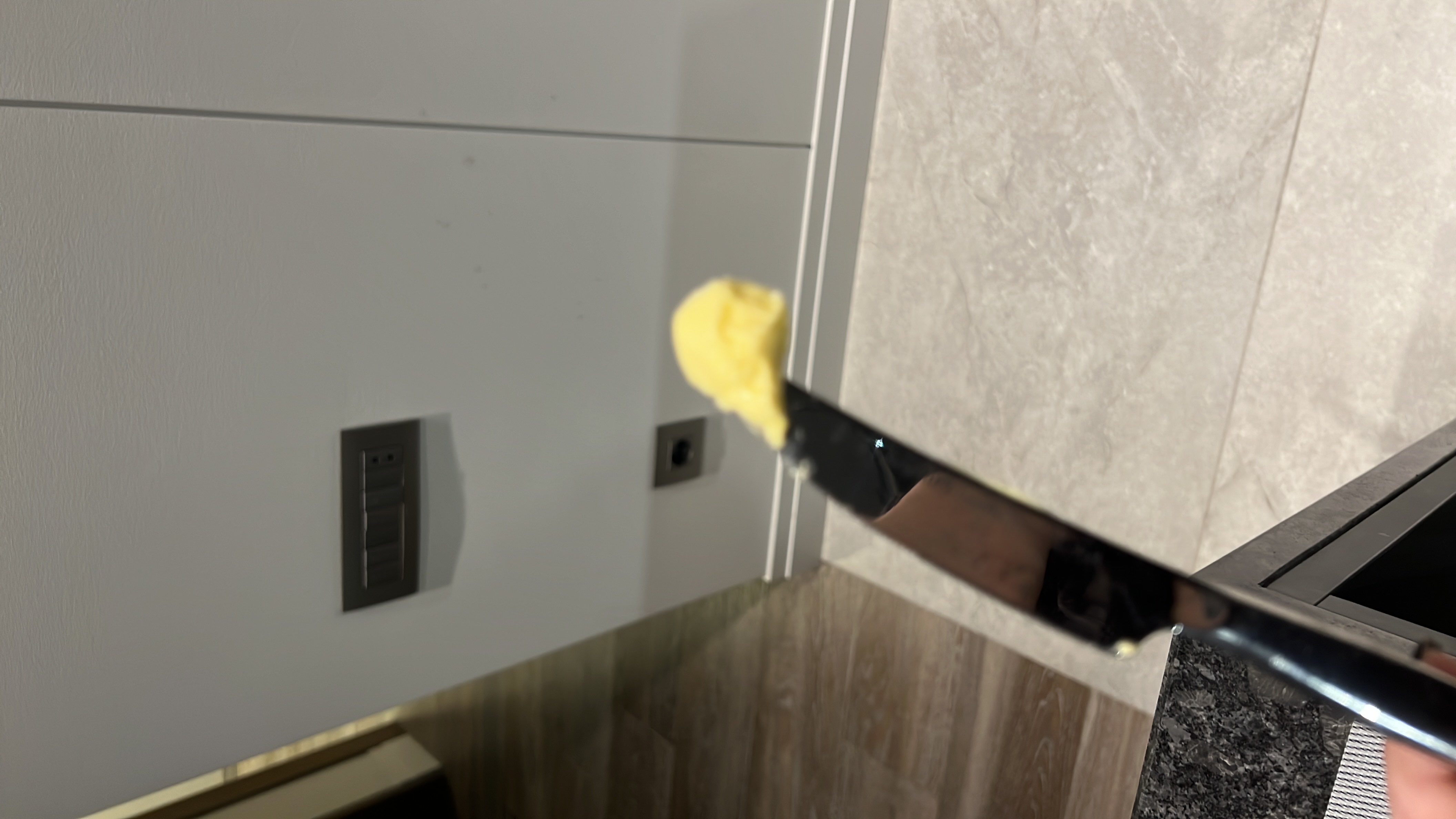 A small portion of butter on a knife, which is high in fats and calories but contains no protein or carbohydrates.