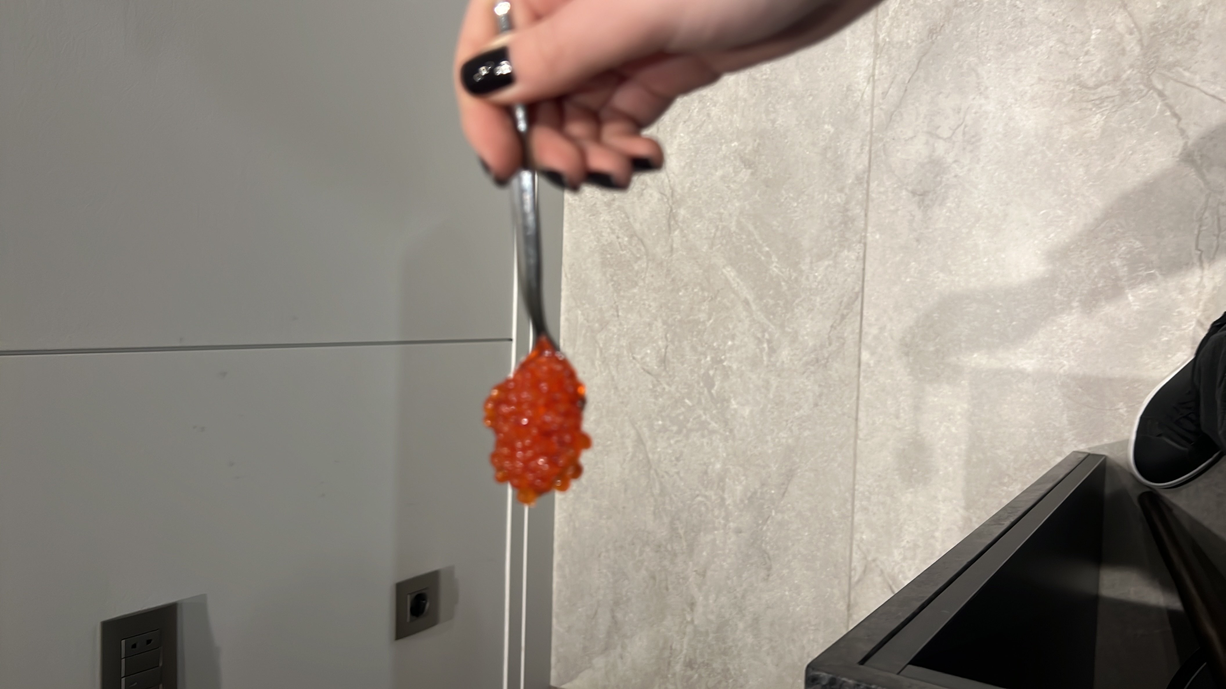 A spoonful of salmon roe, a nutrient-rich seafood delicacy high in protein and healthy fats.