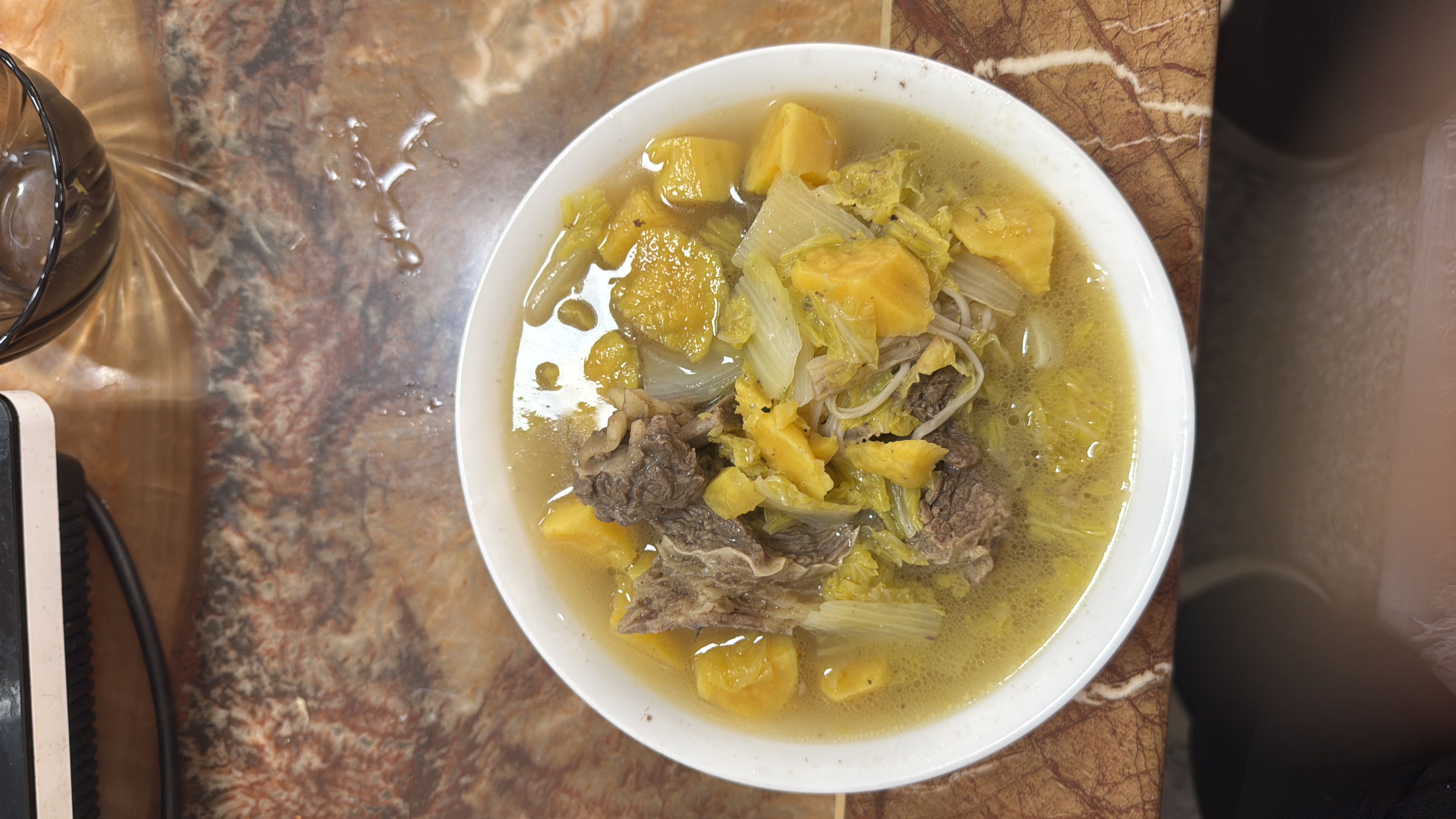 A nutritious beef and vegetable soup with pumpkin, cabbage, and onions in a flavorful broth.