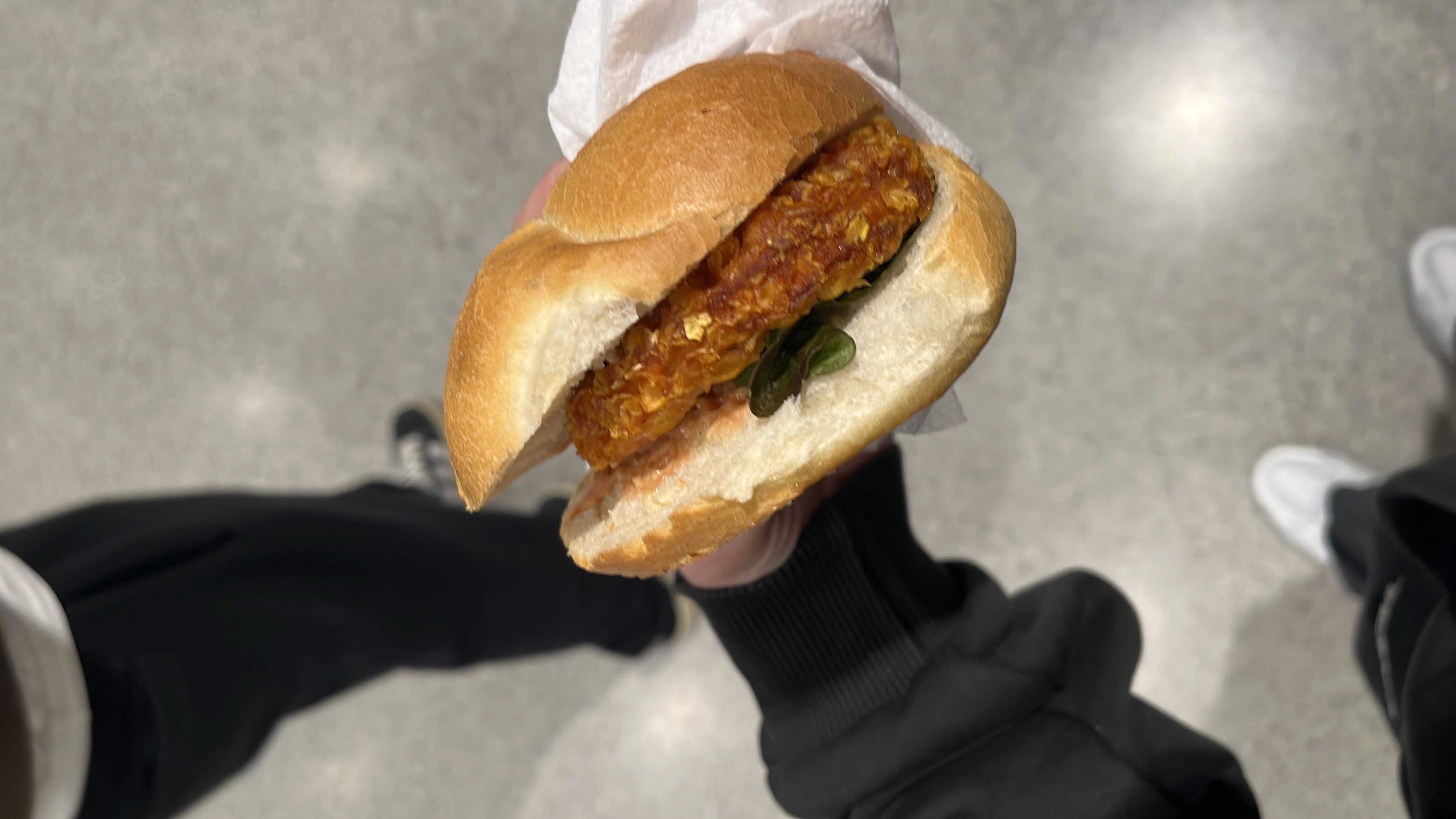 A veggie burger with a crispy patty, fresh lettuce, and sauce in a soft bun.