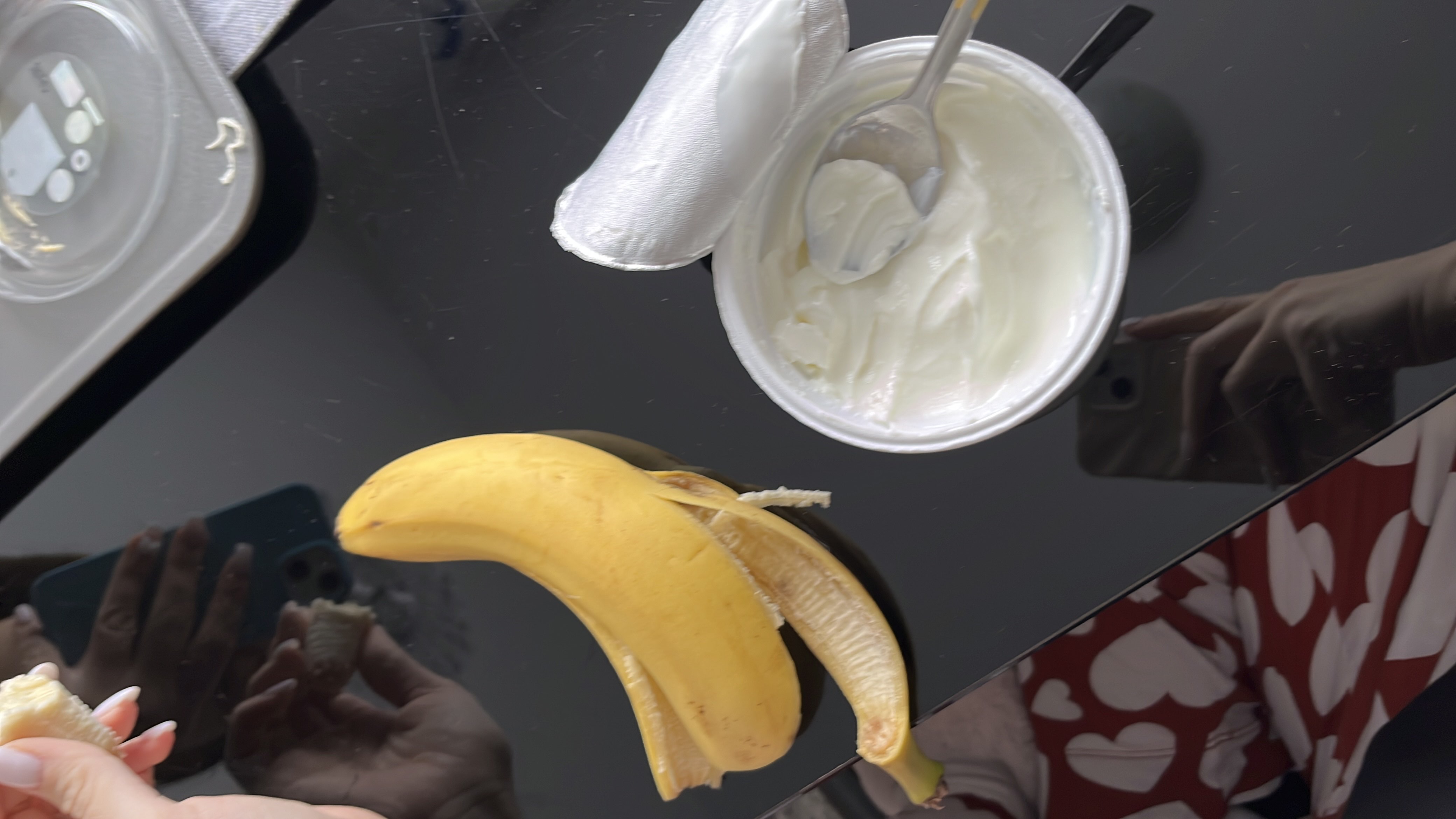 A healthy snack consisting of a banana and Greek yogurt, providing a good balance of protein, carbohydrates, and fats.