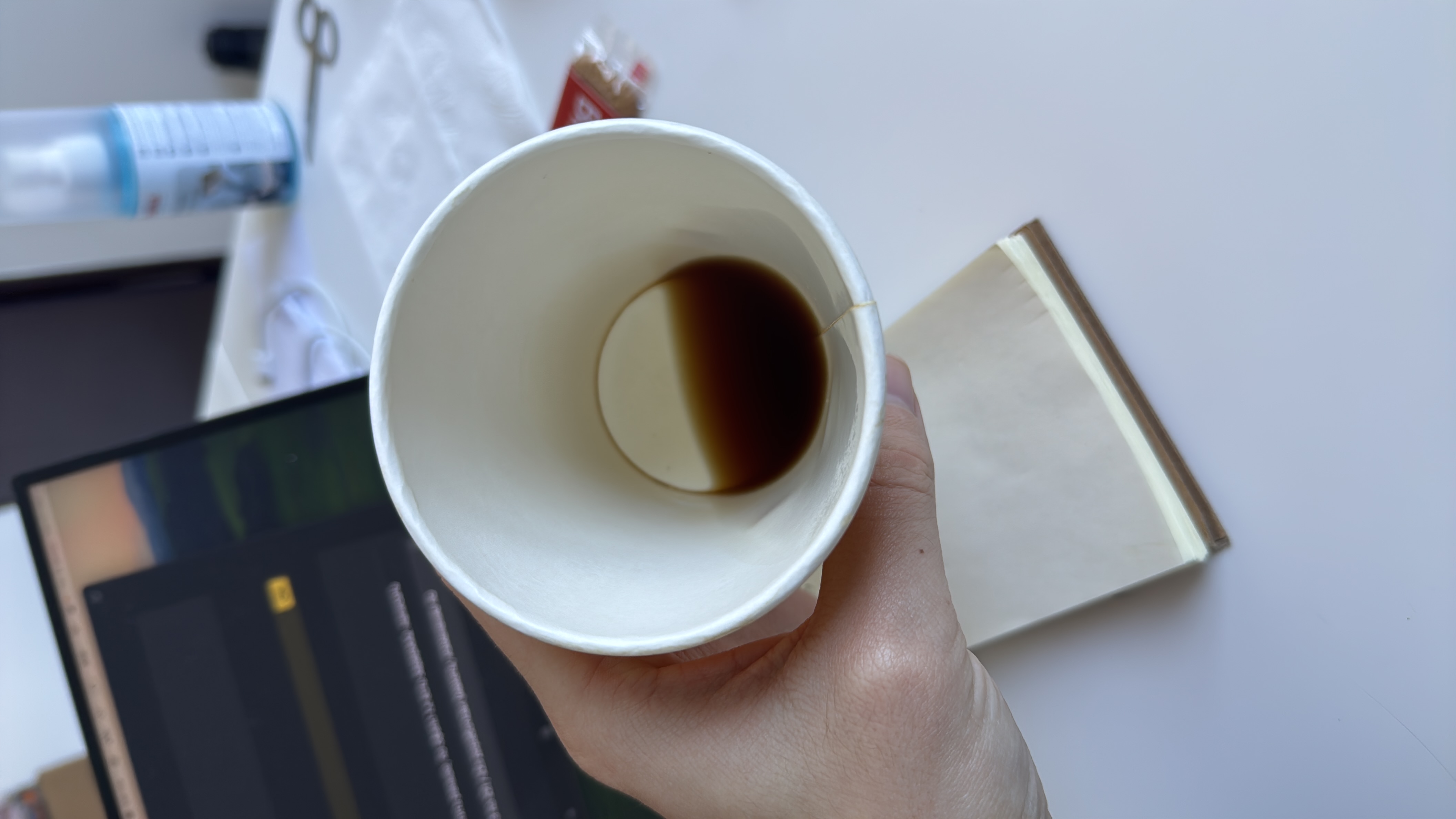 A nearly empty cup containing black coffee, which is low in calories and contains no significant macronutrients.
