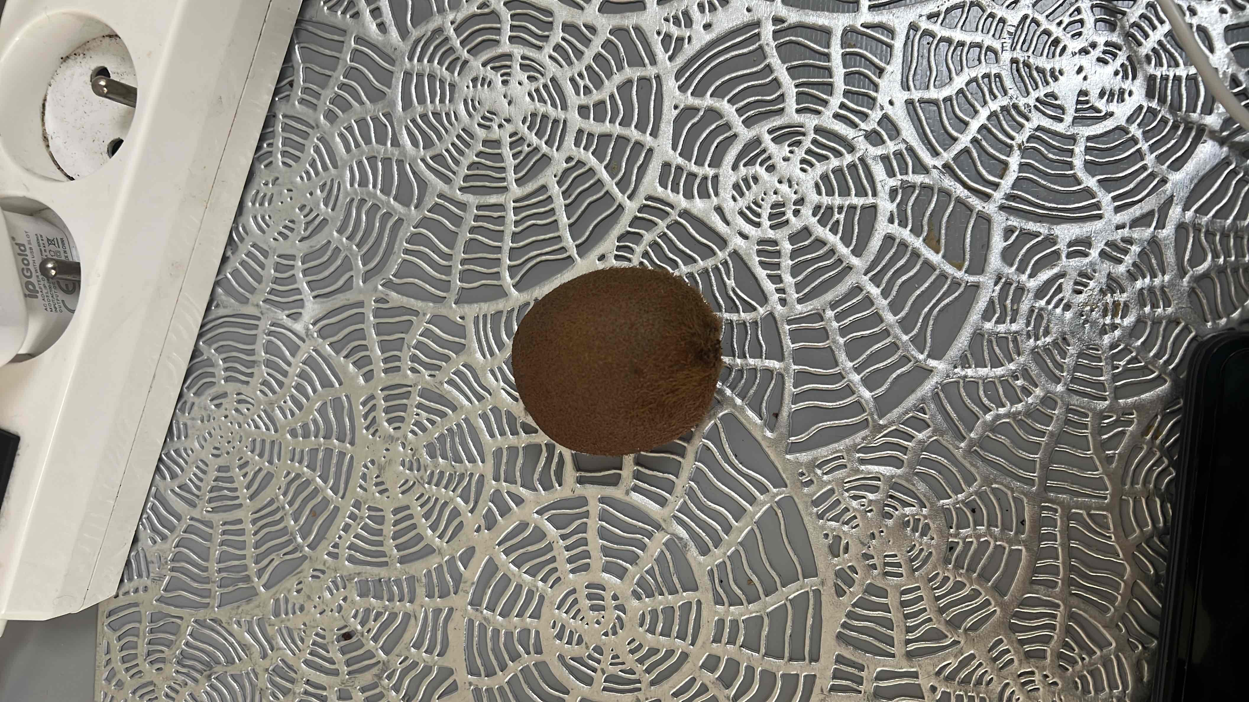 A whole kiwi fruit, which is rich in vitamin C, fiber, and antioxidants, providing a nutritious and low-calorie snack.