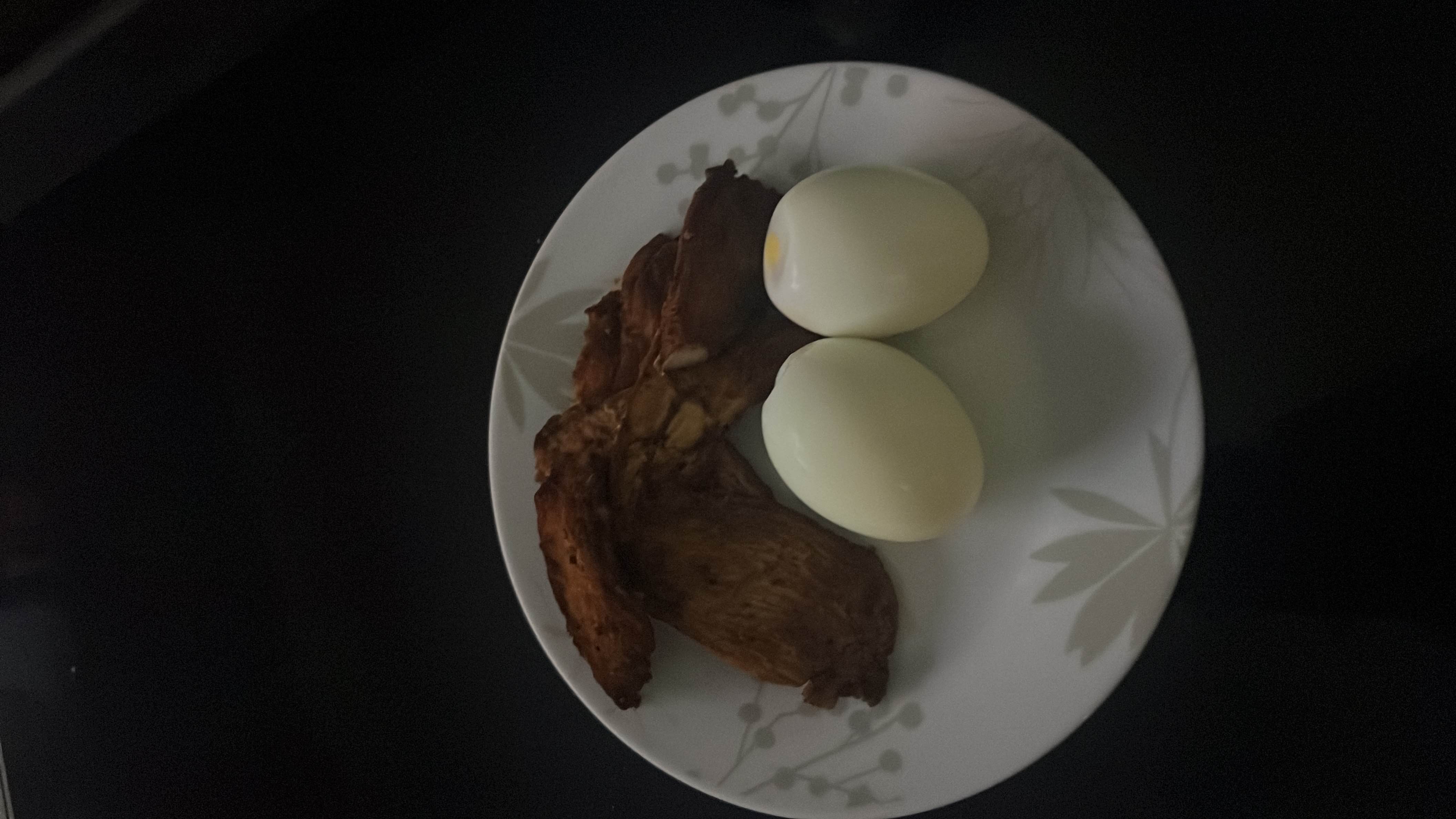 A high-protein meal consisting of grilled chicken and boiled eggs, low in carbohydrates and rich in essential nutrients.