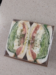 A sandwich containing lettuce, tomato, egg, cheese, and bread, providing a balanced mix of protein, carbs, and fats.