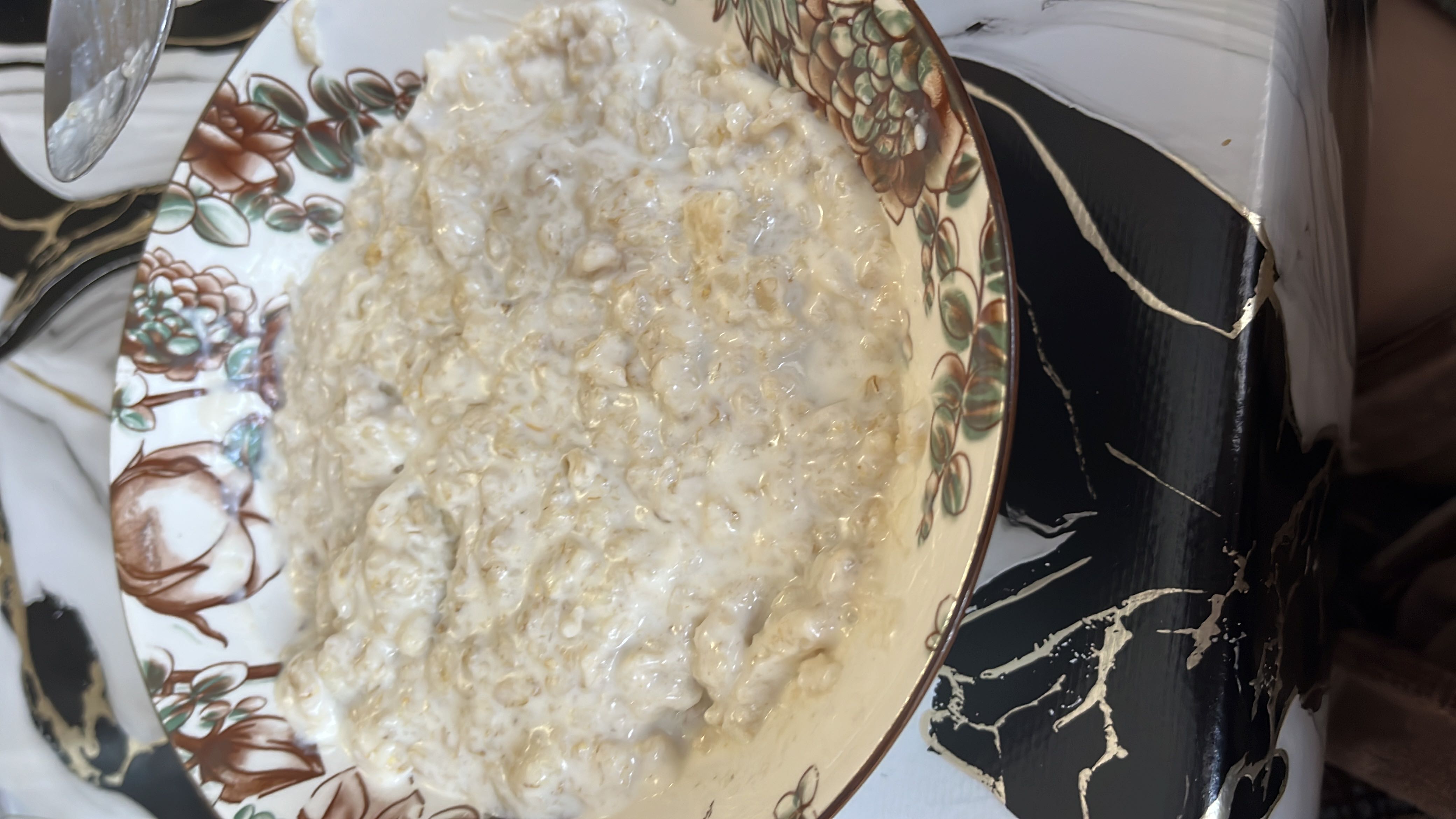 A bowl of creamy oatmeal made with oats and milk, providing a balanced mix of carbohydrates, protein, and fats.