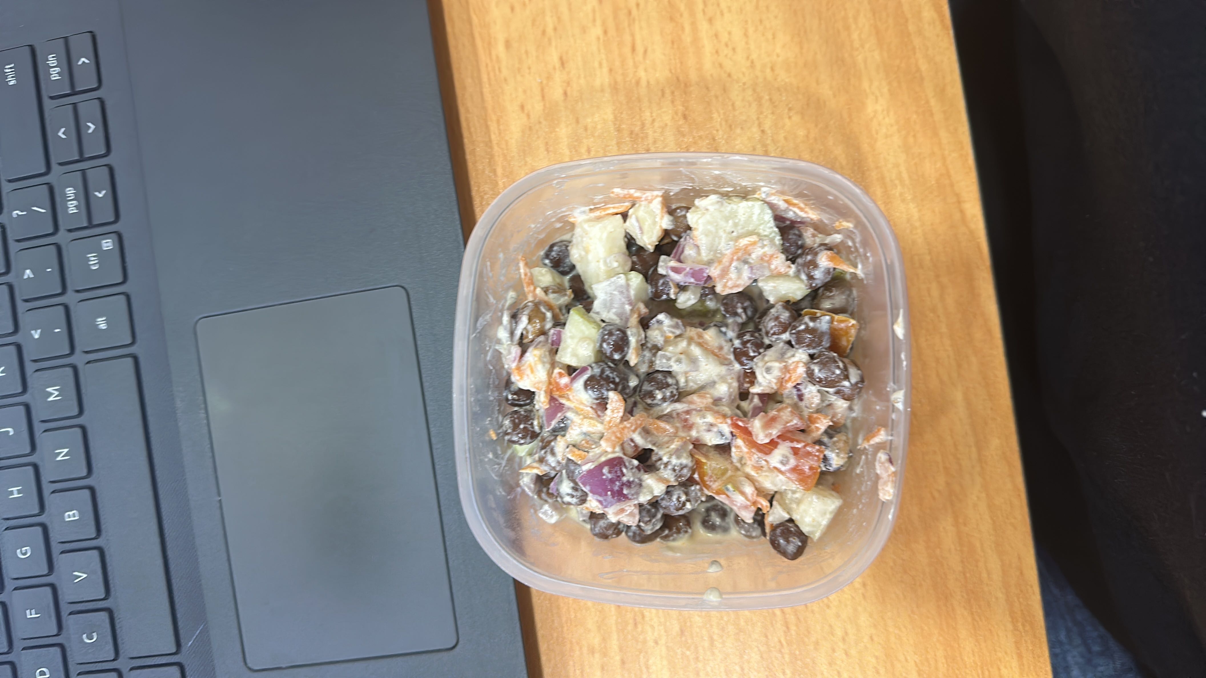 A healthy chickpea salad with fresh vegetables and a yogurt-based dressing, providing a balanced mix of protein, carbs, and fats.