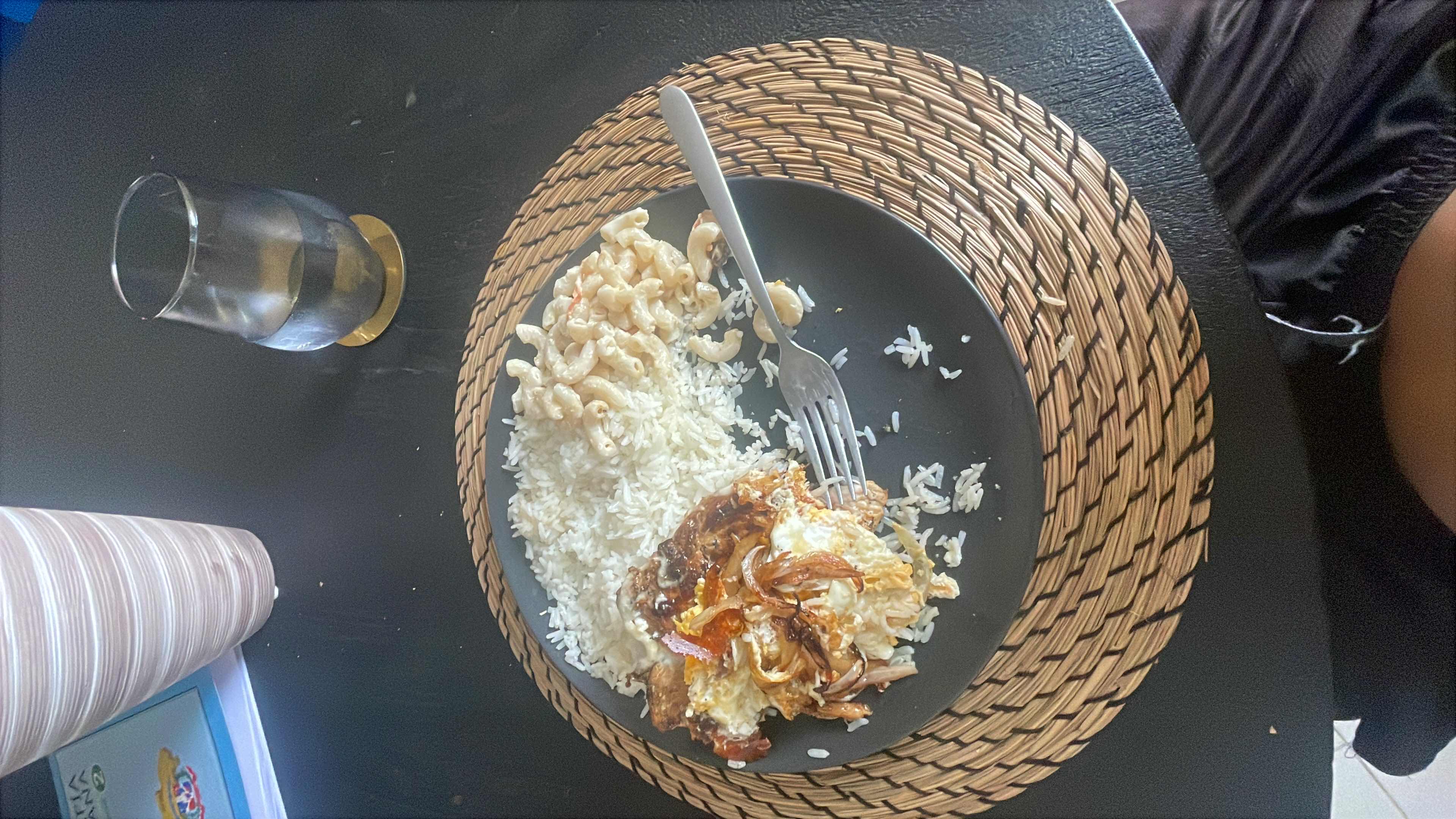 A meal consisting of white rice, macaroni with sauce, fried egg, and shredded meat, providing a balanced mix of carbohydrates, protein, and fats.