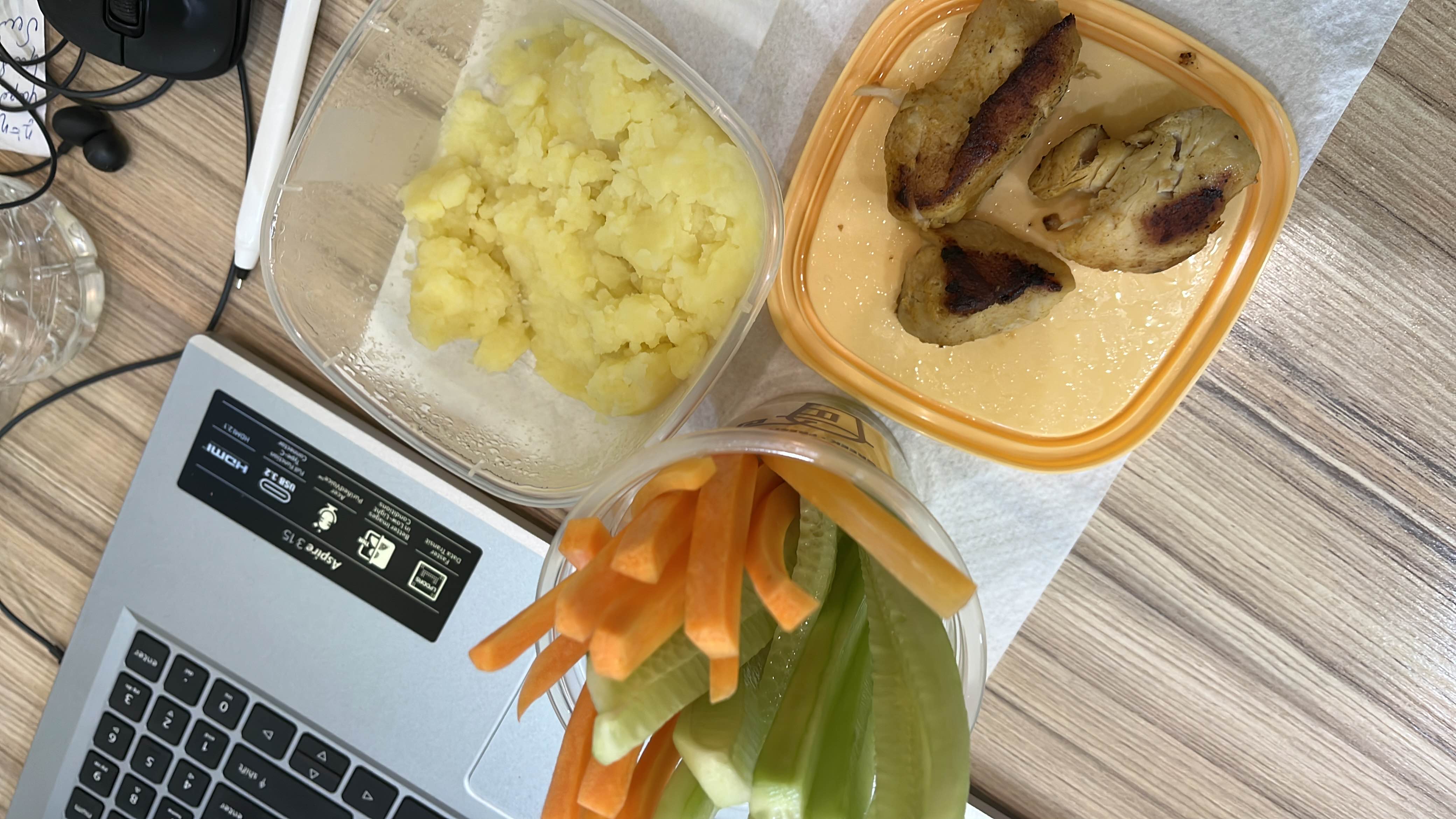 A balanced meal consisting of grilled chicken, mashed potatoes, and fresh vegetable sticks (carrots and celery), providing a good mix of protein, carbohydrates, and fiber.