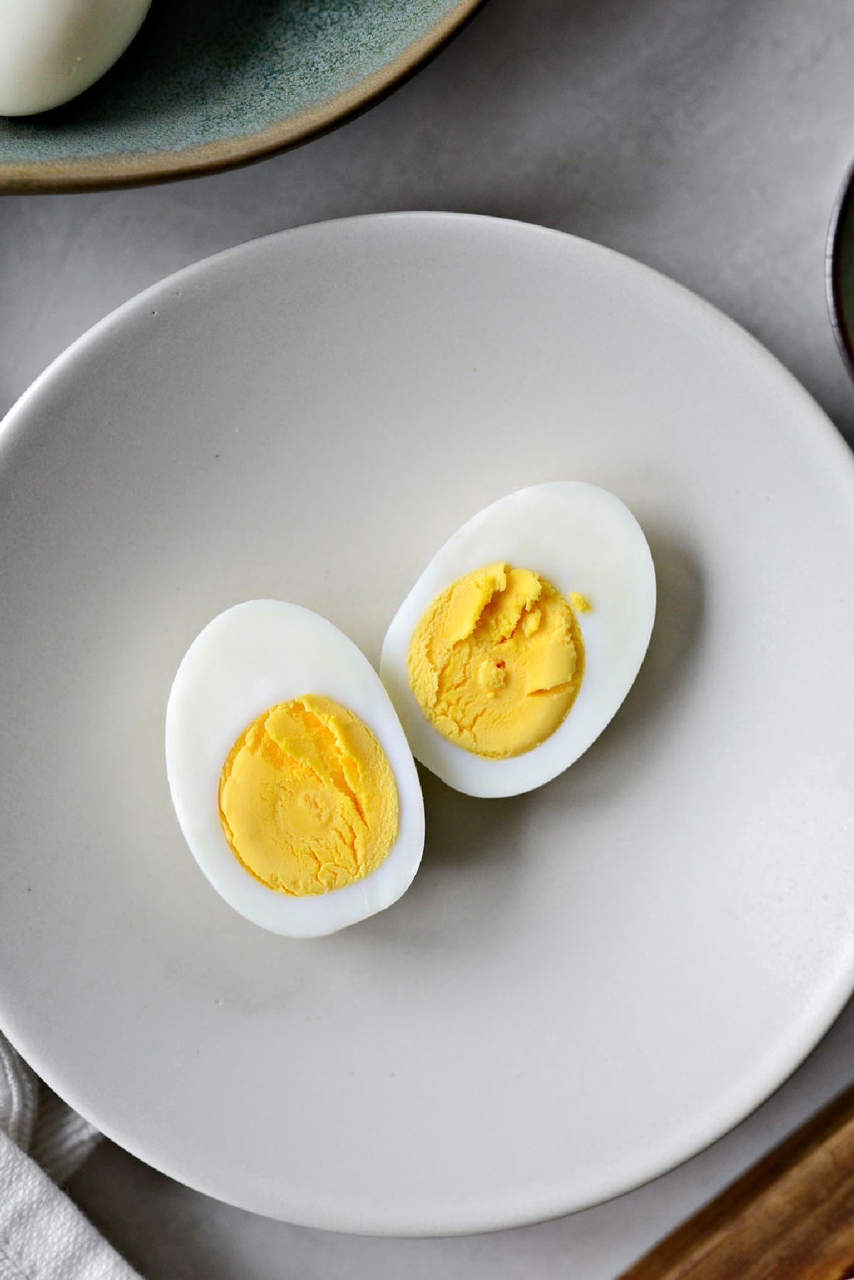 A hard-boiled egg, a nutritious source of protein and healthy fats, commonly consumed as a snack or part of a meal.