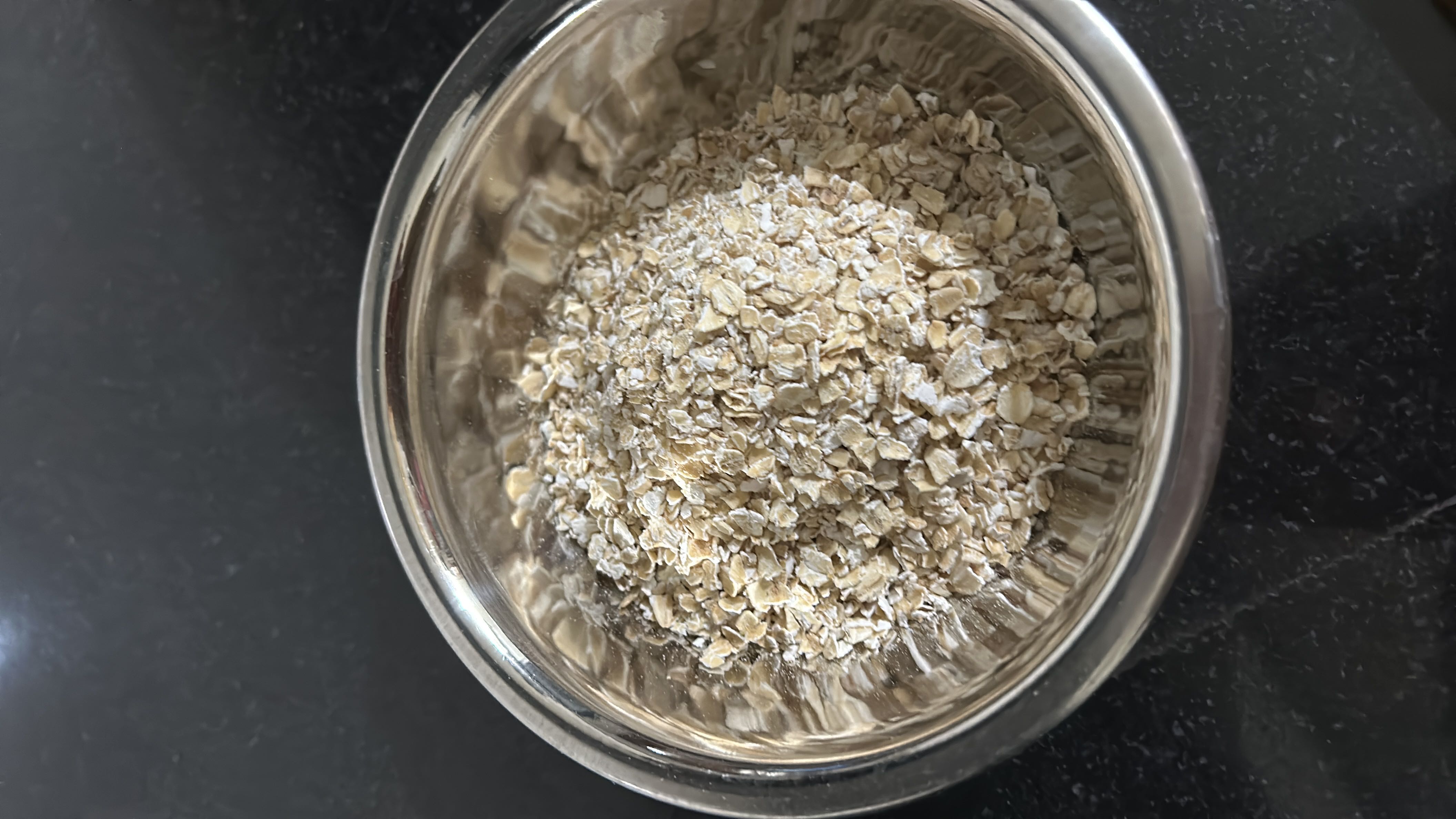 A bowl of rolled oats, a nutritious whole grain rich in fiber, protein, and essential nutrients.