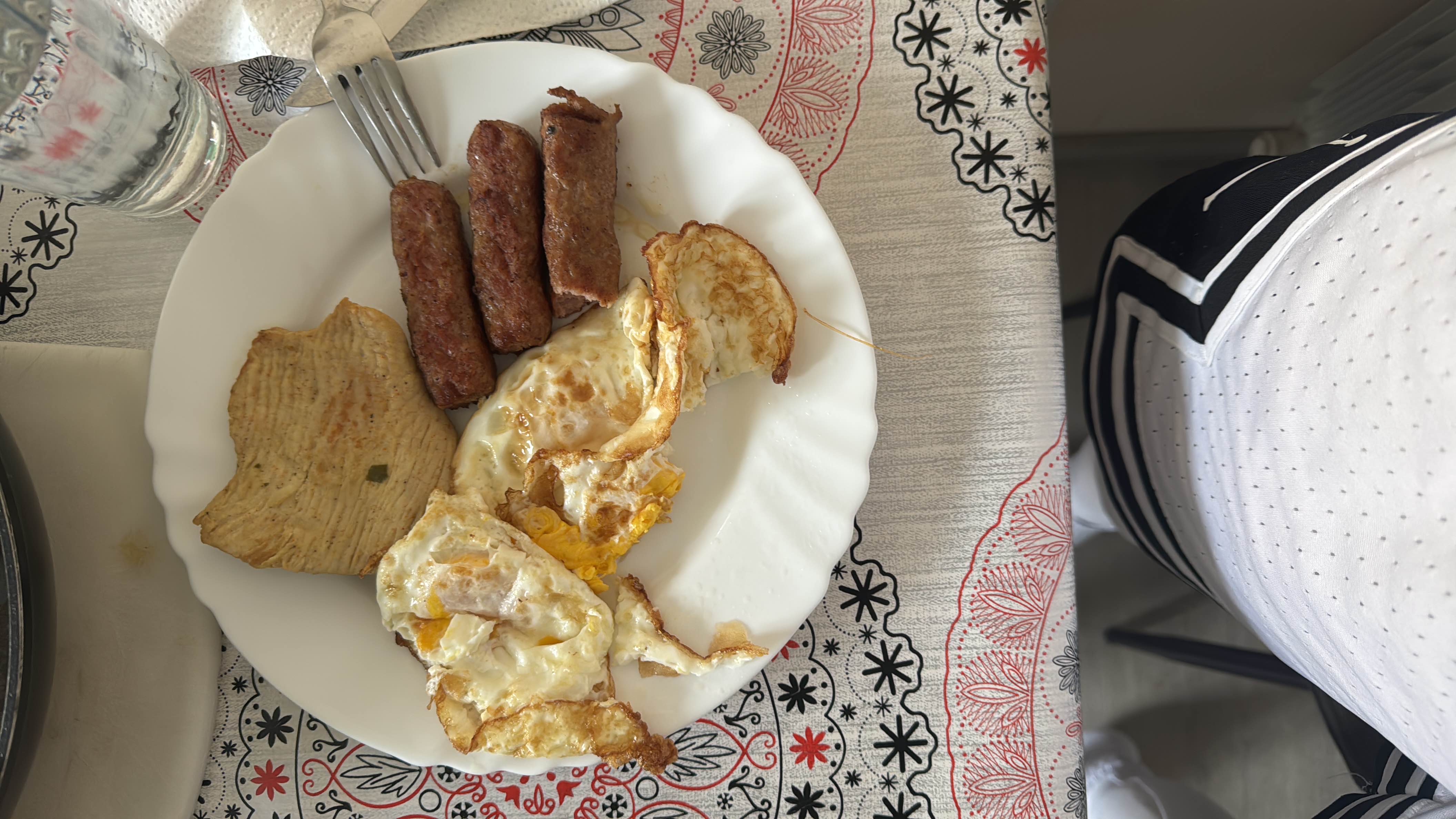 A high-protein meal consisting of fried eggs, grilled turkey, and sausages, providing a balanced mix of fats and protein with minimal carbohydrates.