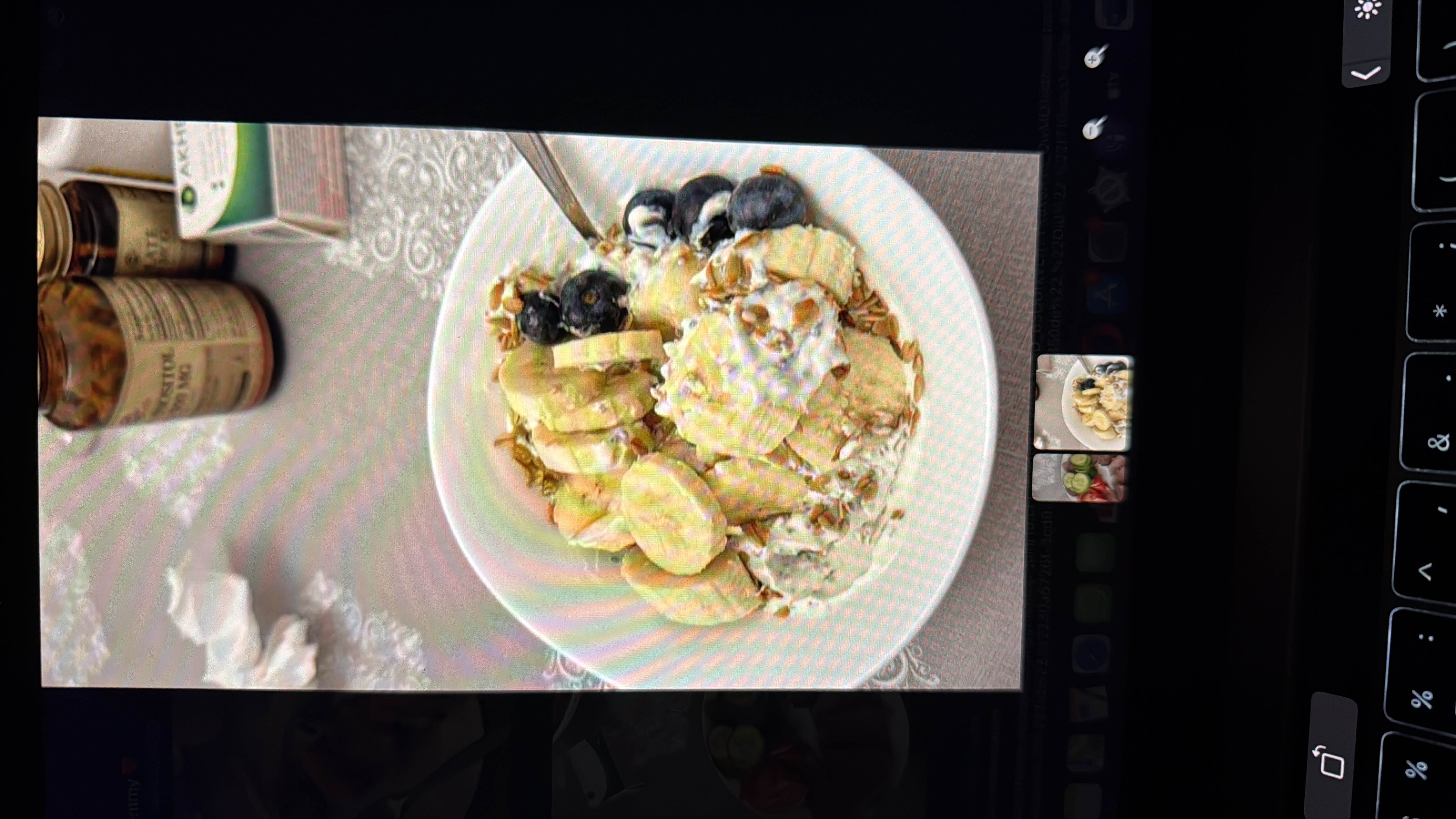 A nutritious bowl containing Greek yogurt, granola, banana slices, and blueberries, providing a balanced mix of protein, carbs, and healthy fats.