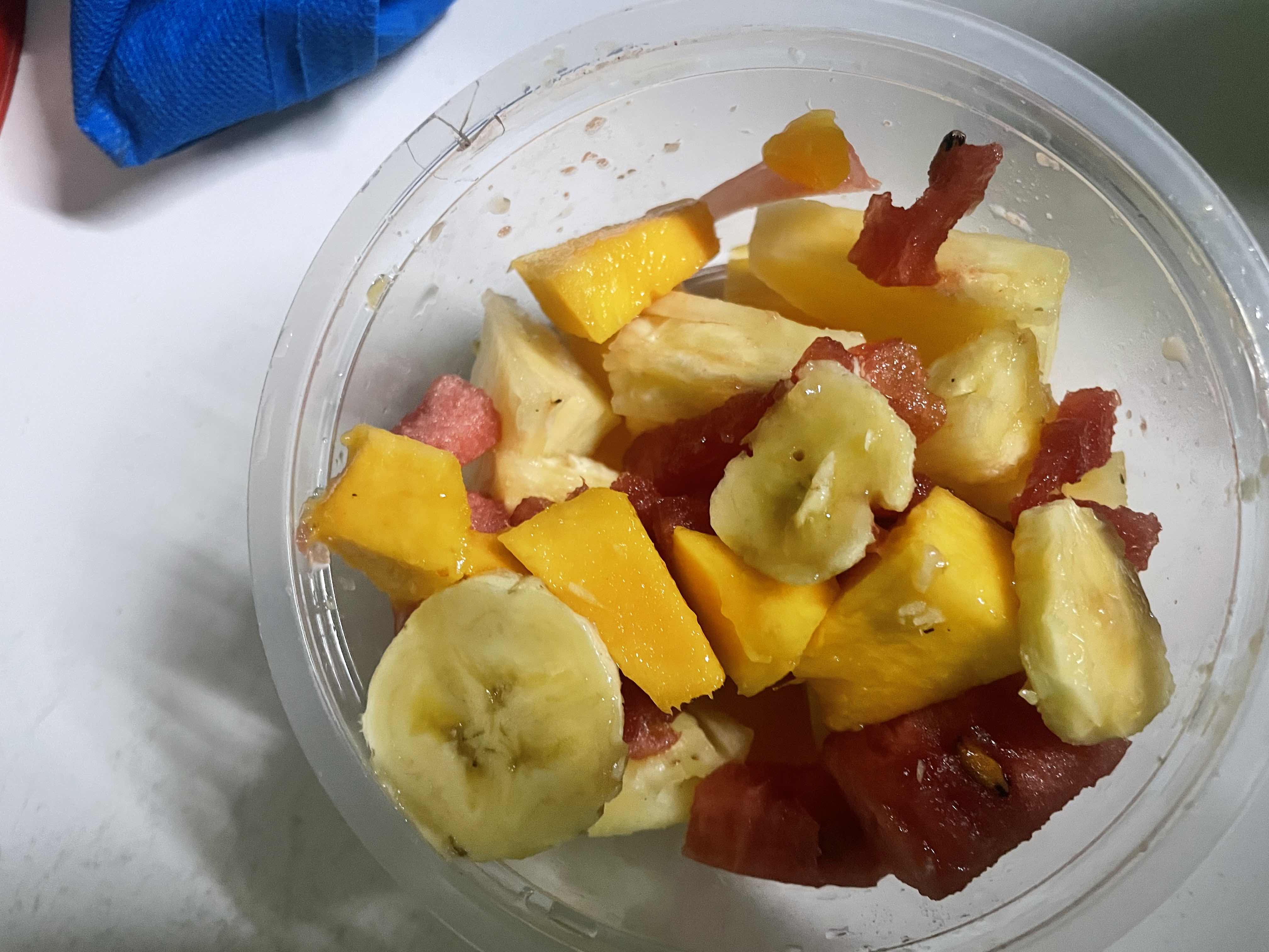 A fresh fruit salad containing banana, mango, watermelon, and pineapple, providing a healthy mix of natural sugars, fiber, and vitamins.