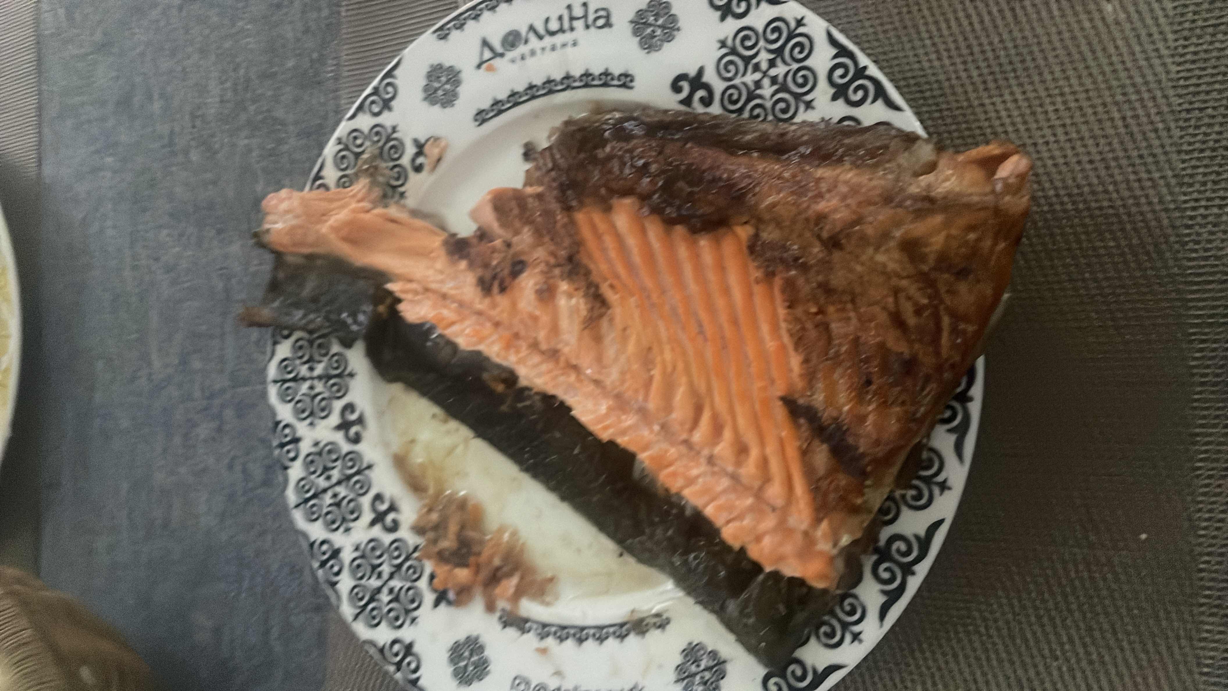 A serving of grilled salmon, rich in protein and healthy fats, providing a nutritious meal with minimal carbohydrates.