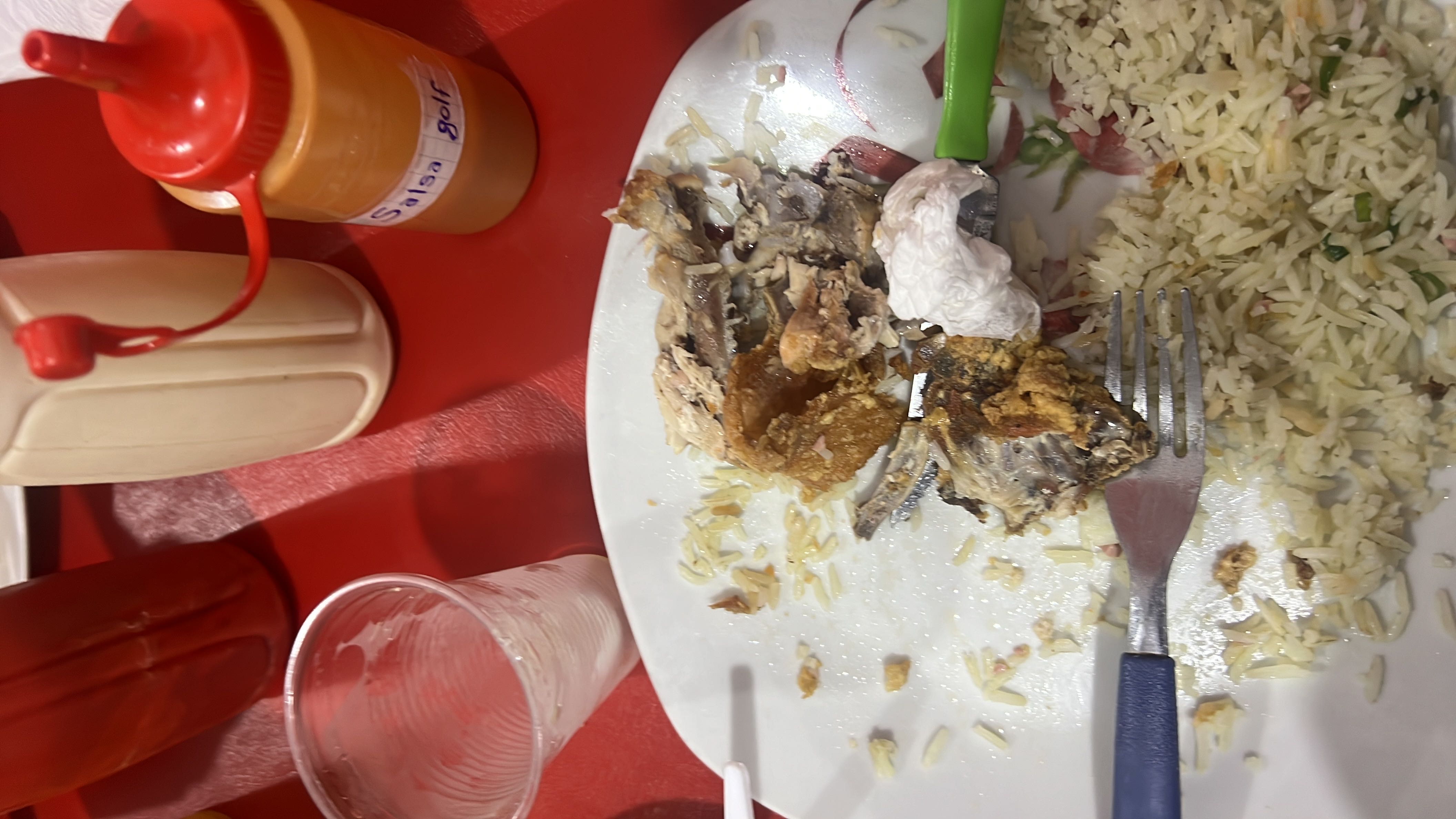 A meal consisting of fried fish, rice, and condiments, providing a balanced mix of protein, carbohydrates, and fats.