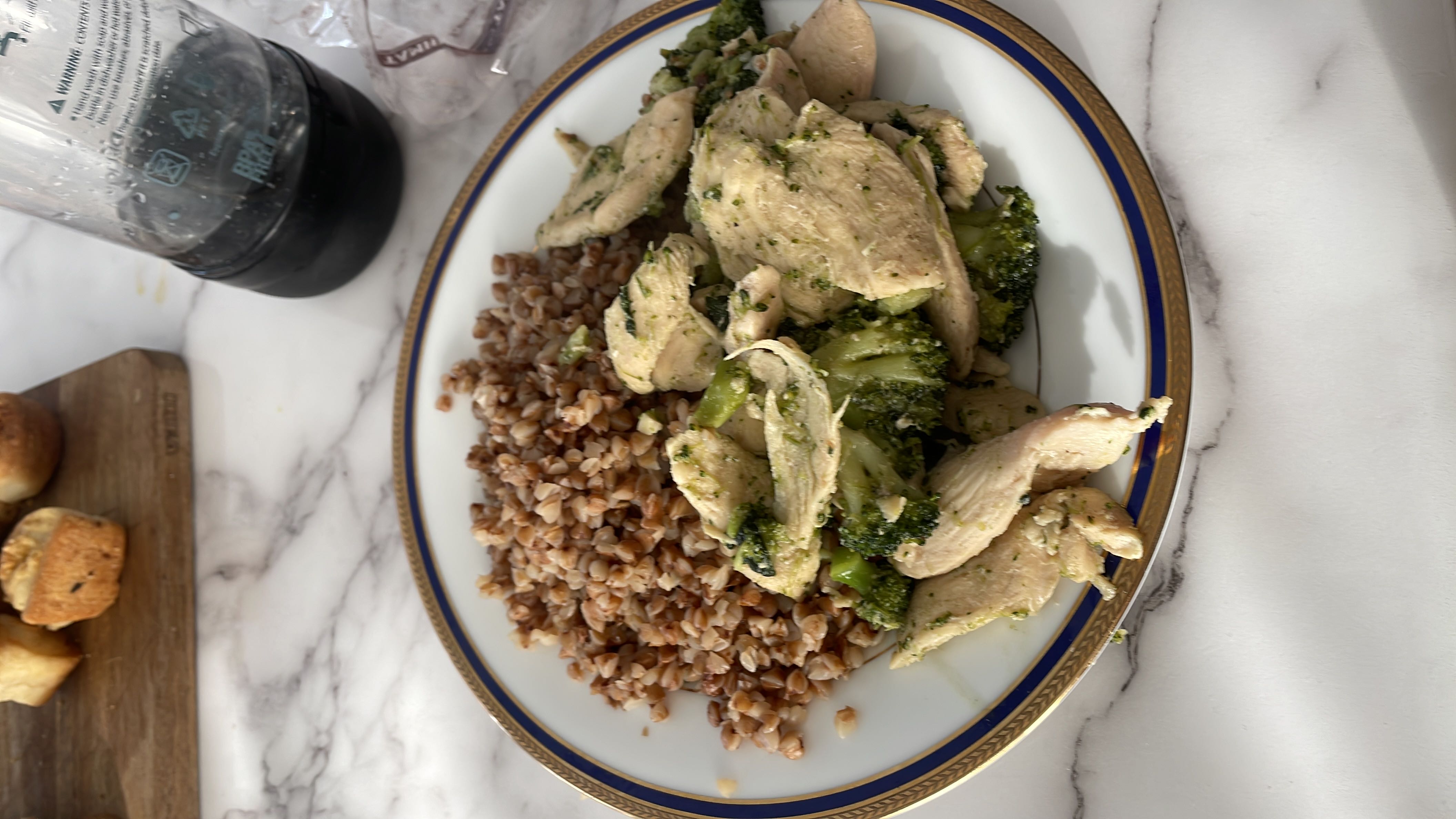 A nutritious meal consisting of grilled chicken breast, steamed broccoli, and cooked buckwheat, providing a balanced mix of protein, carbohydrates, and healthy fats.