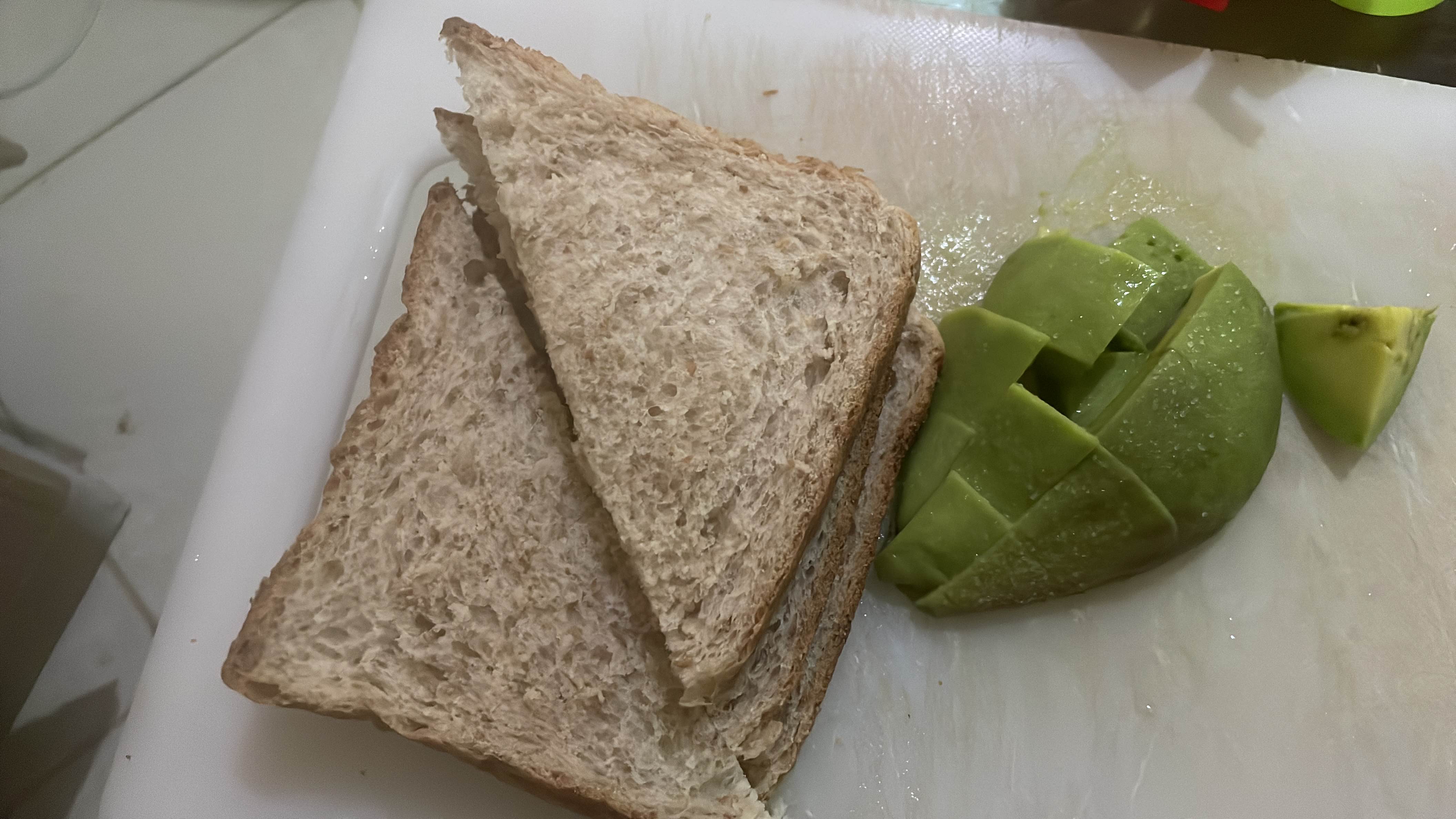 A simple meal consisting of whole wheat bread and fresh avocado, providing a balanced mix of carbohydrates, healthy fats, and protein.