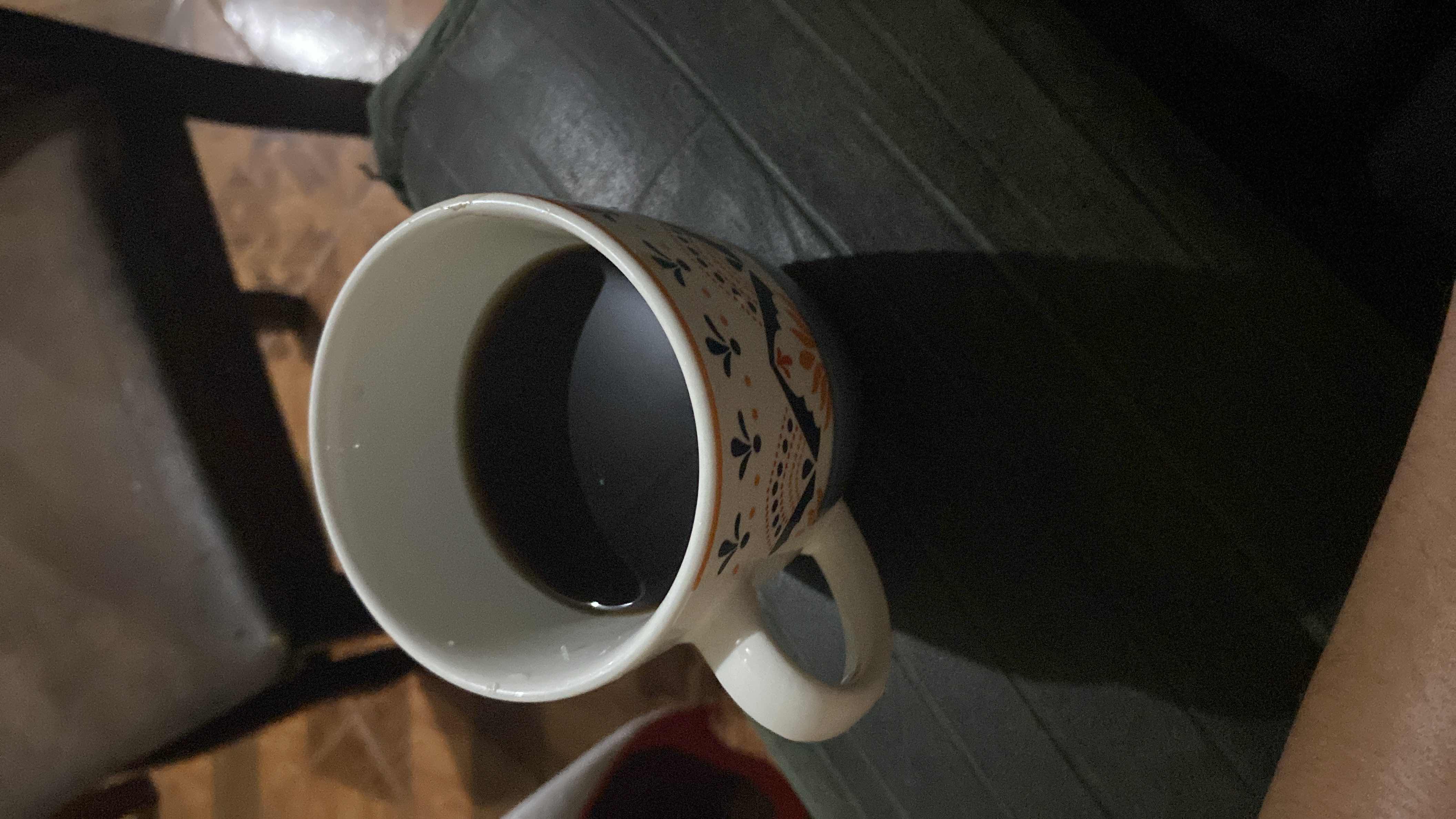 A cup of black coffee, which is low in calories and contains no fats or carbohydrates, making it a healthy beverage choice.