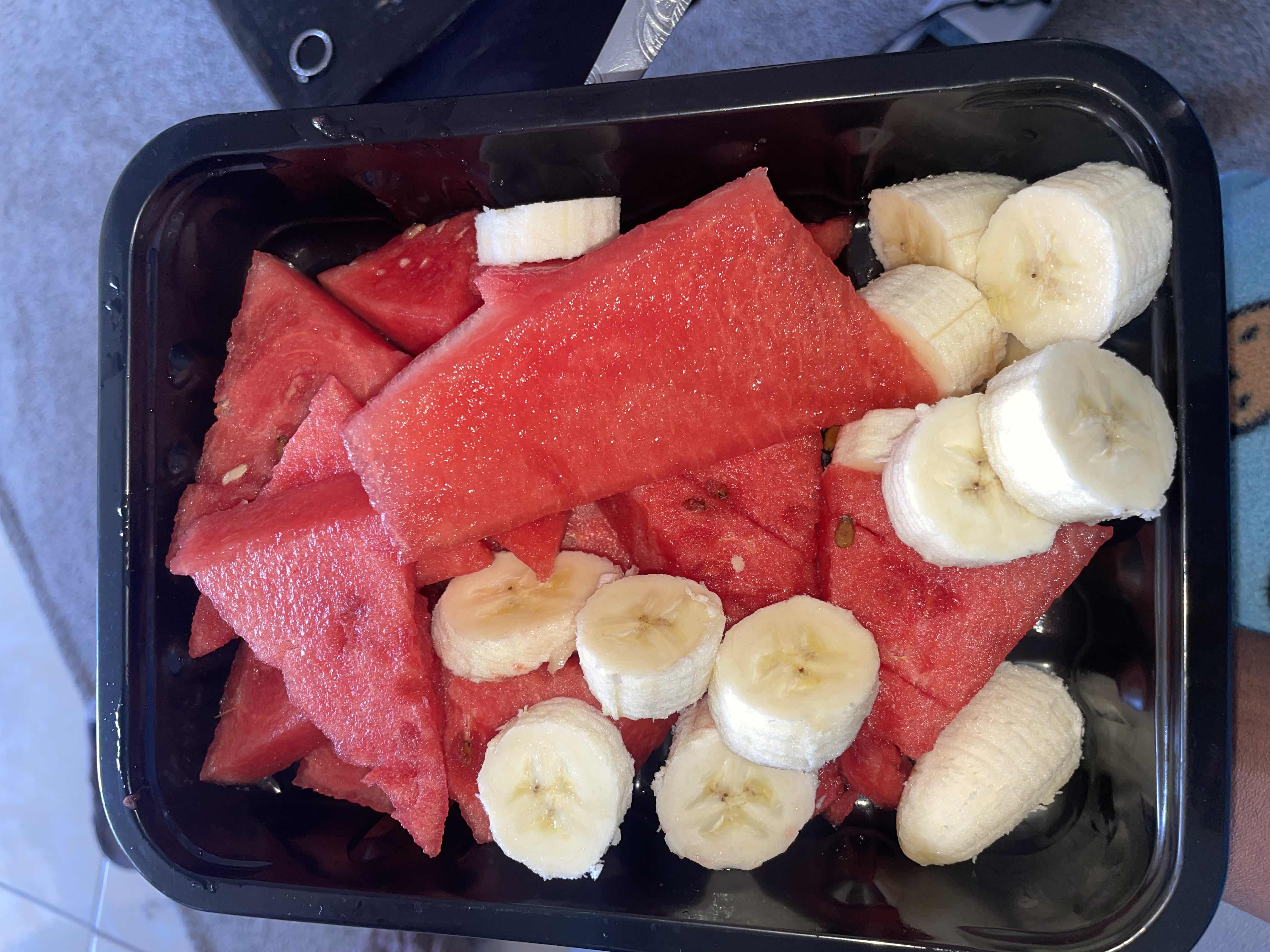 A fresh fruit mix containing watermelon and banana, providing a hydrating and nutritious snack with natural sugars and fiber.