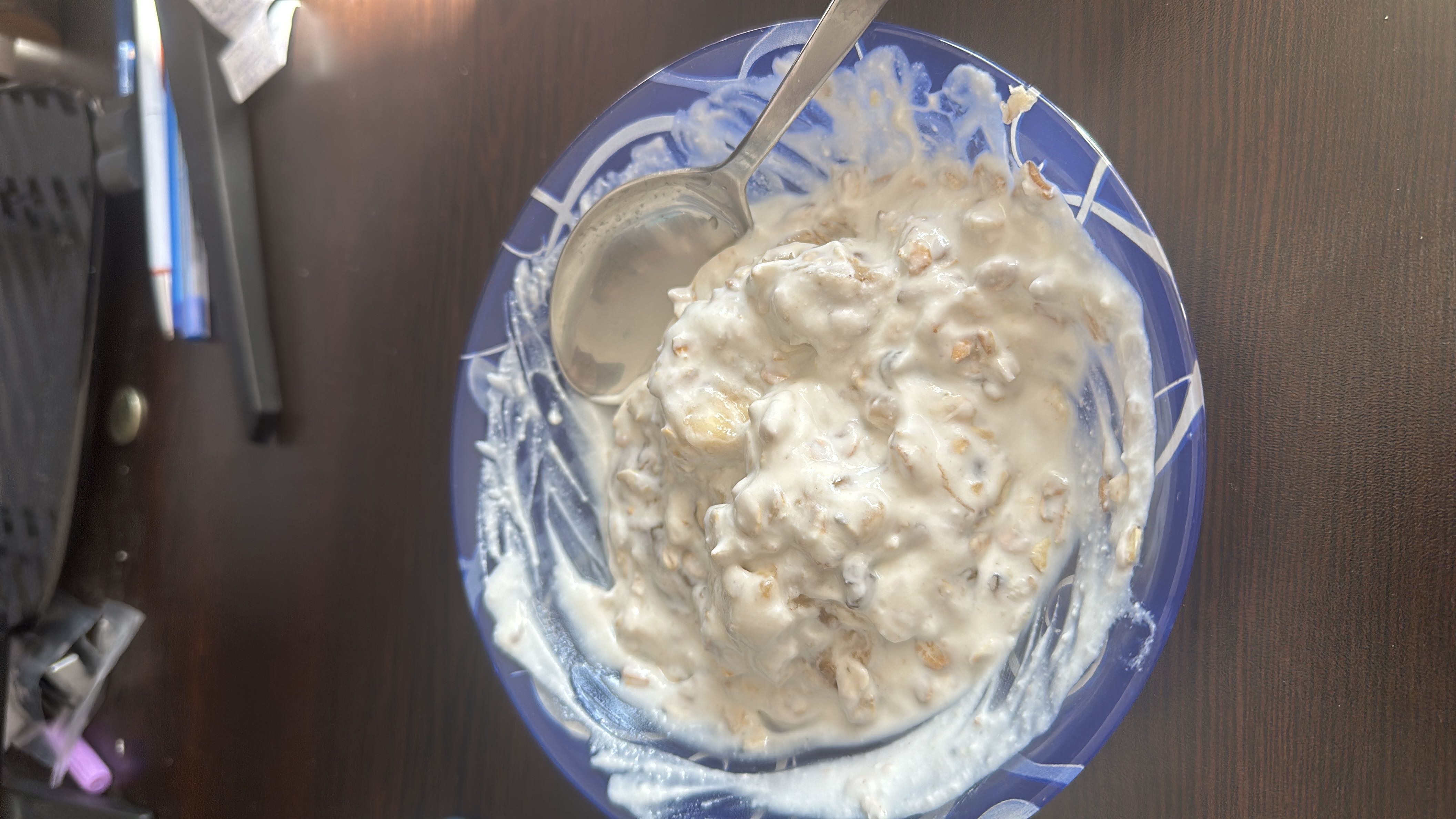 A nutritious bowl of yogurt mixed with granola and banana, providing a balanced combination of protein, carbohydrates, and healthy fats.
