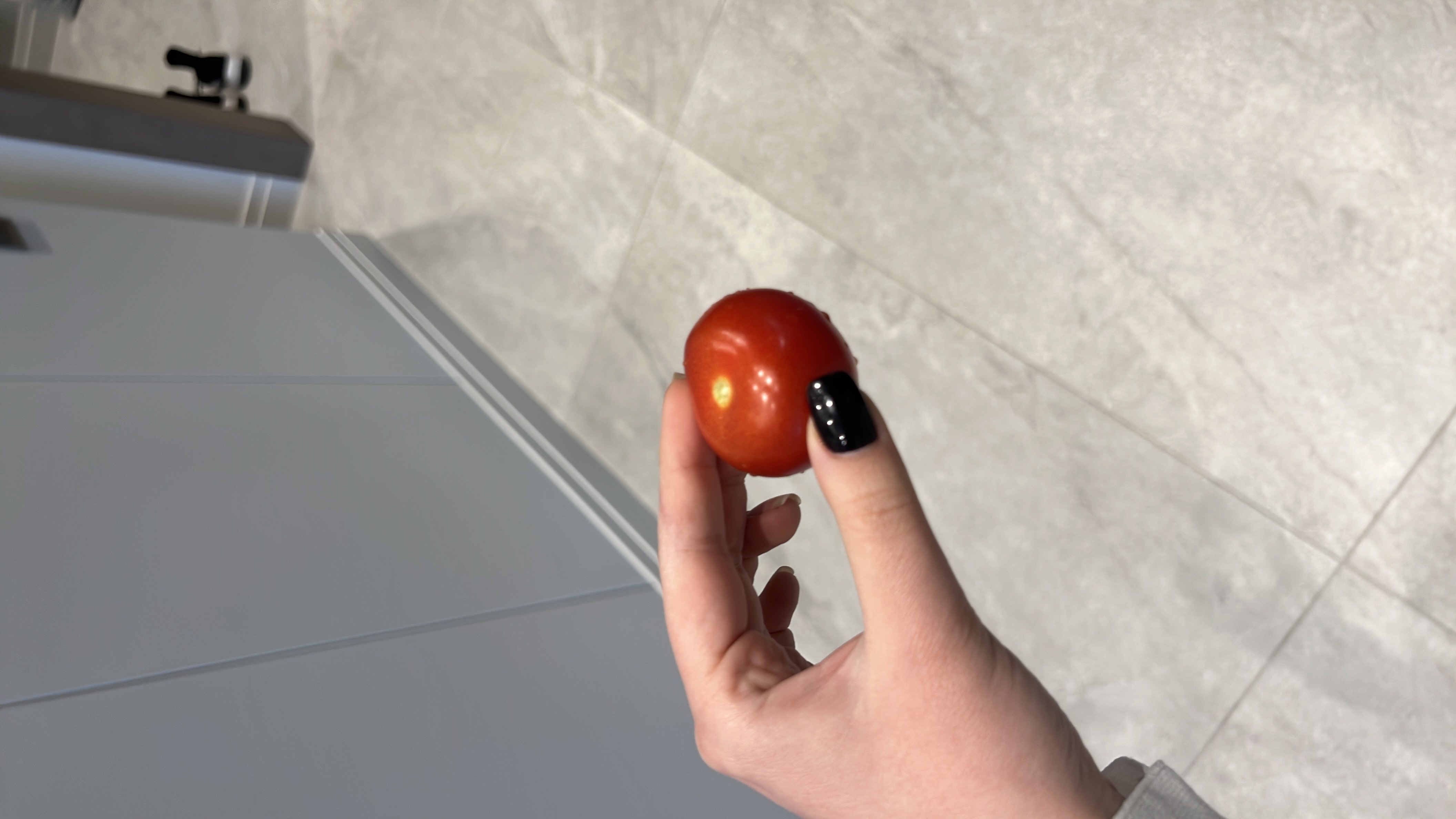 A fresh cherry tomato, low in calories and rich in nutrients, ideal for a healthy snack.