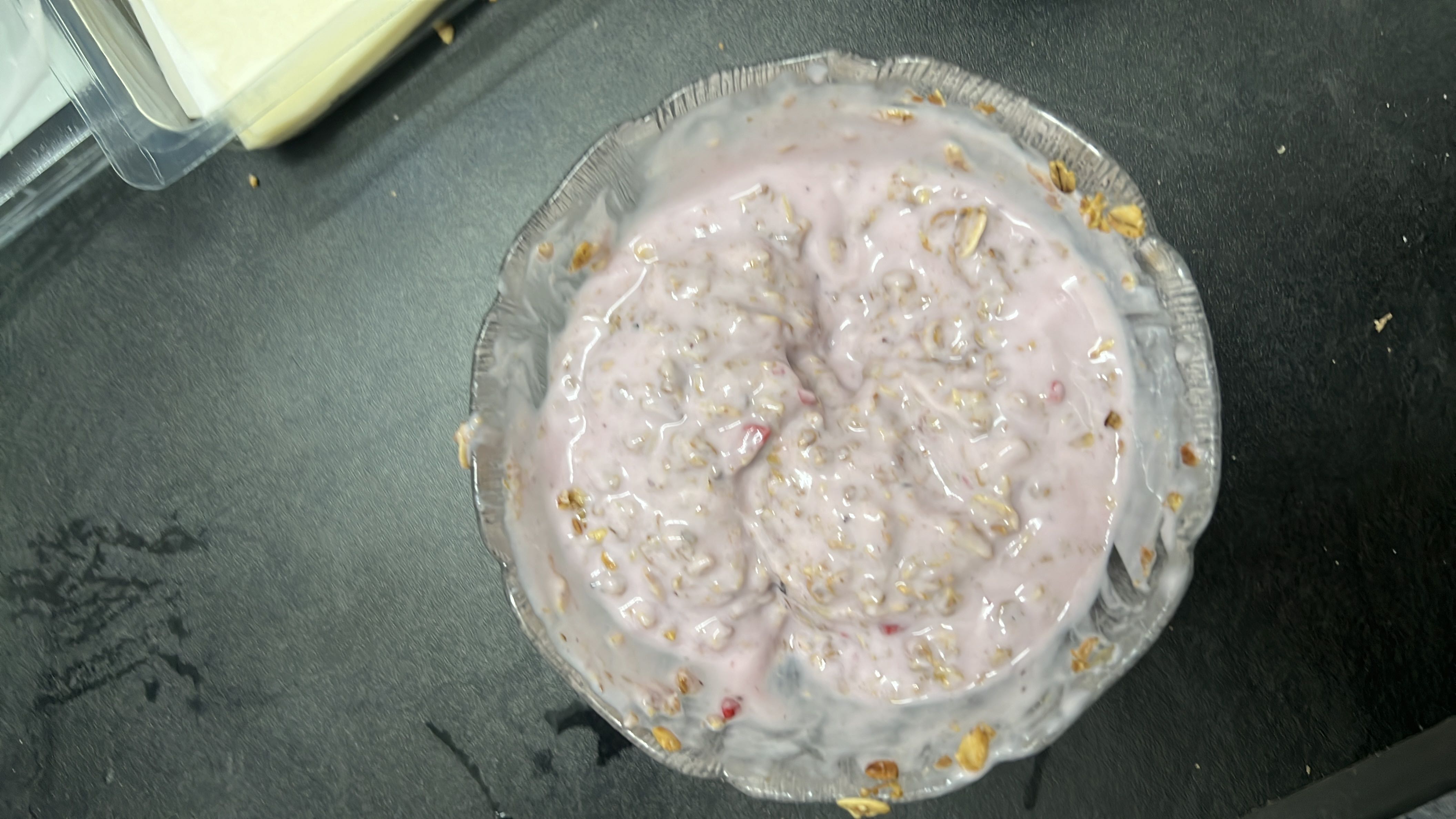 A bowl of yogurt mixed with oats and berries, providing a balanced combination of protein, carbohydrates, and healthy fats.