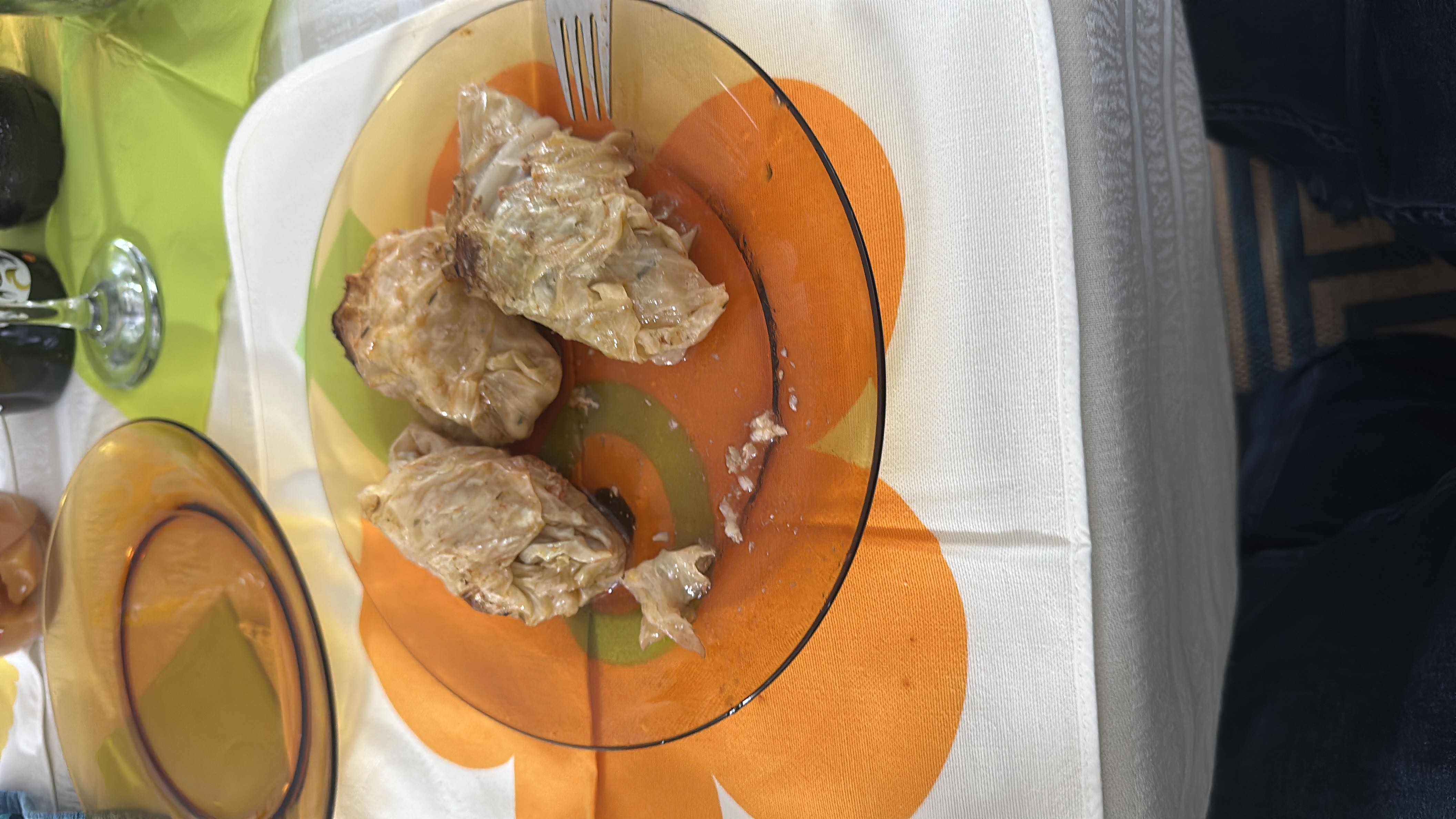 Stuffed cabbage rolls with a filling of ground meat, rice, and spices, cooked to a tender texture.
