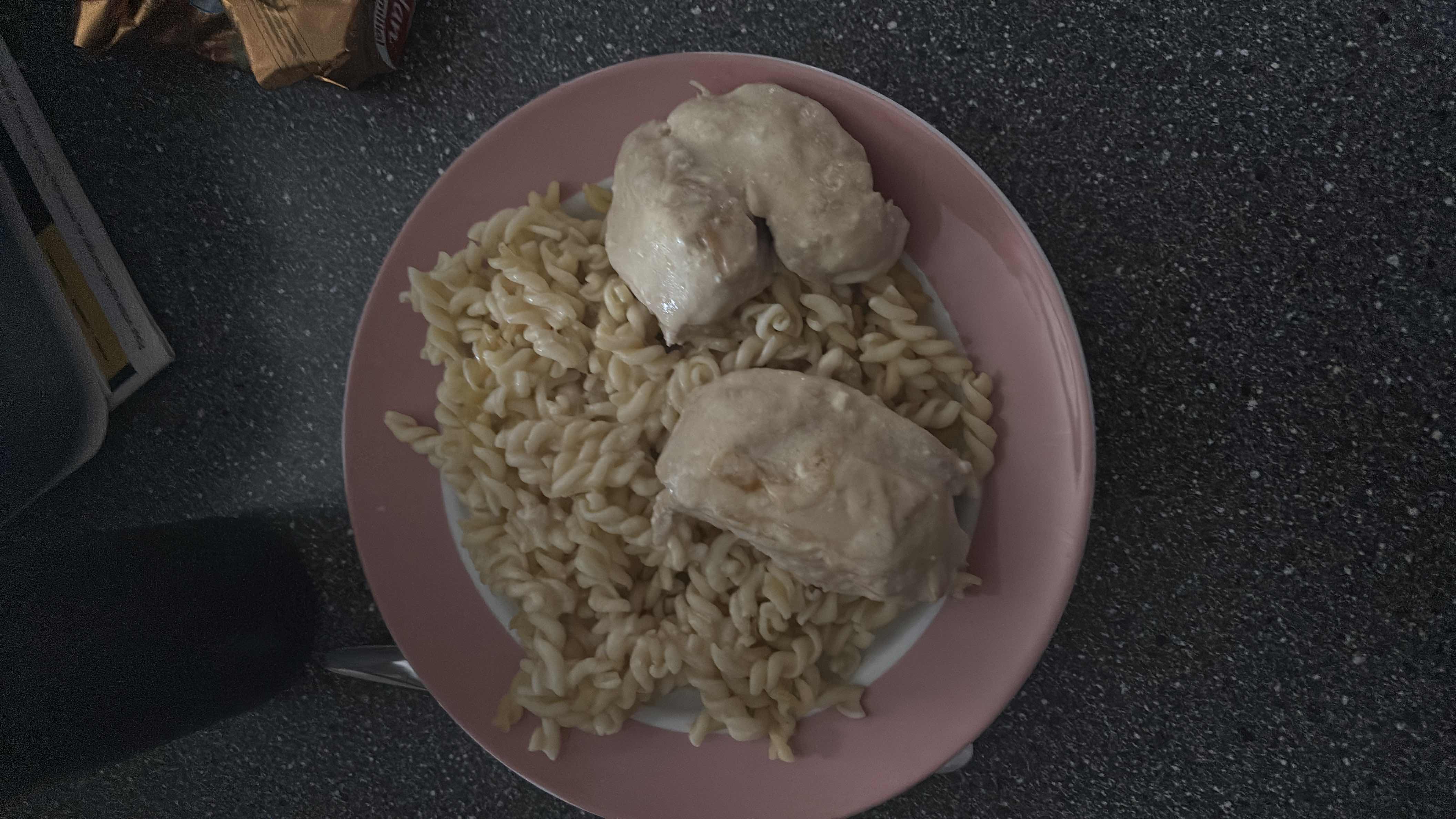 A plate of pasta with creamy chicken, providing a balanced mix of protein, carbohydrates, and fats.