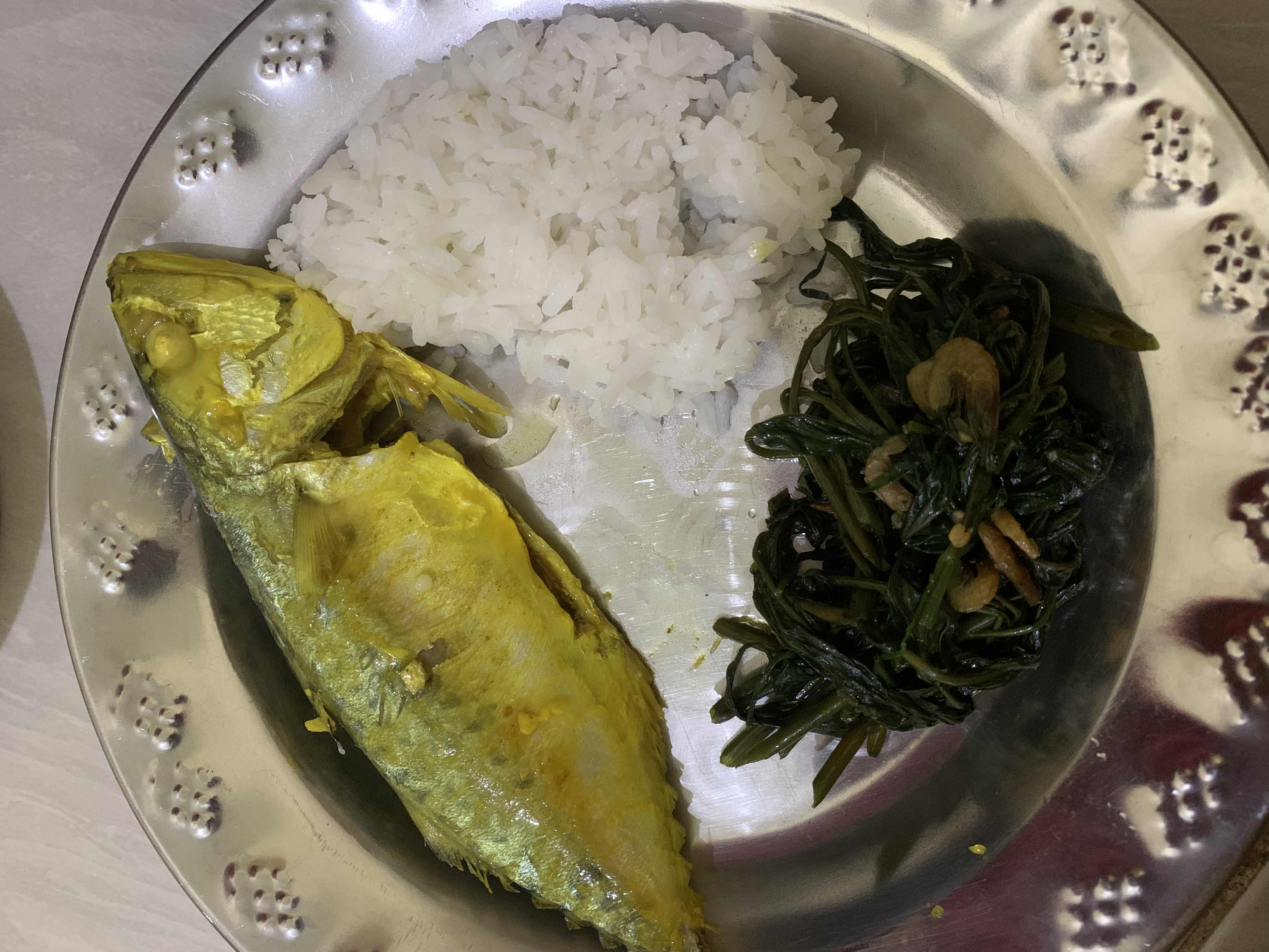 A balanced meal consisting of steamed fish, white rice, and stir-fried greens with shrimp, providing a good mix of protein, carbohydrates, and essential nutrients.