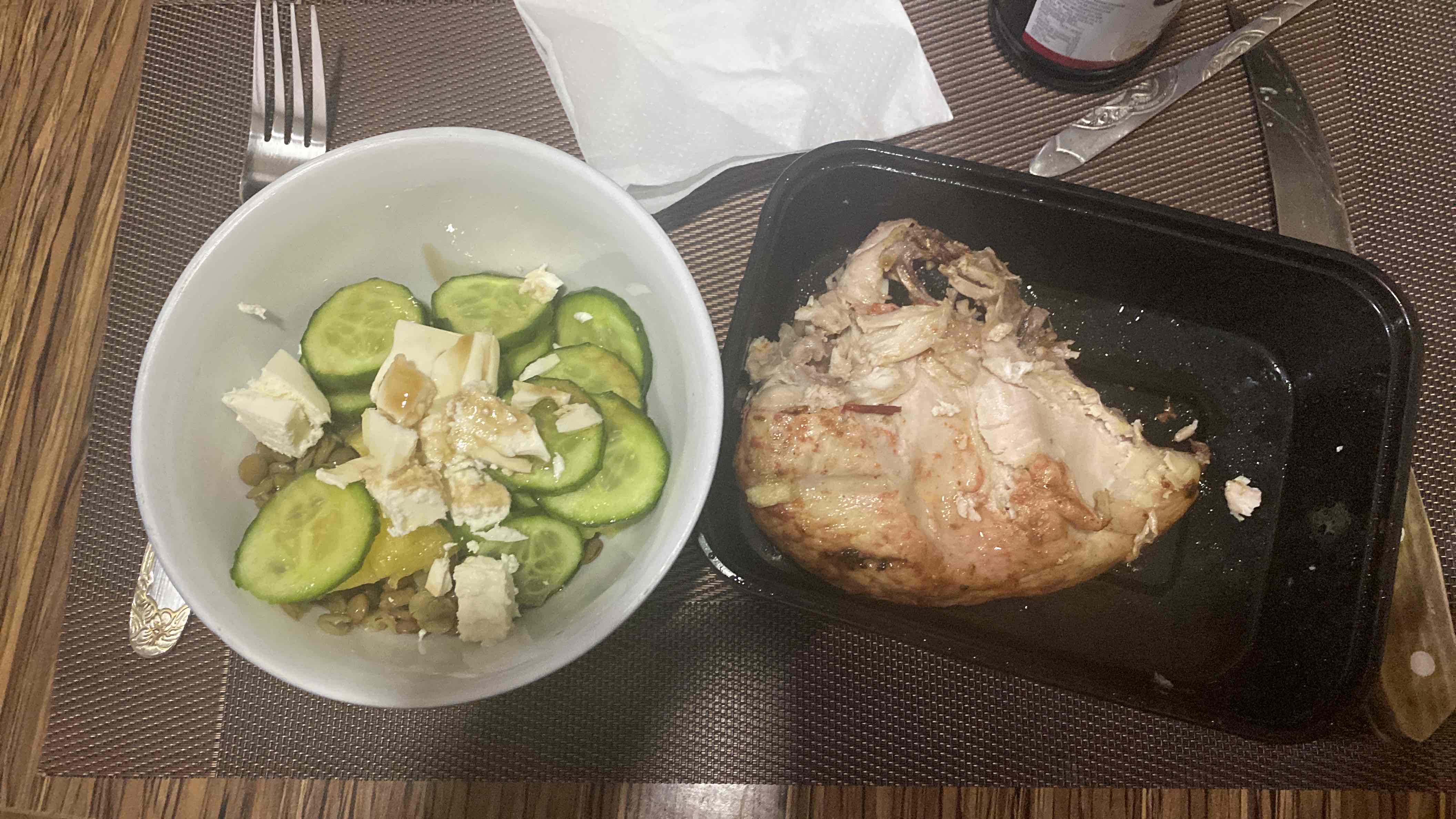 A balanced meal consisting of grilled chicken, a cucumber and lentil salad with feta cheese, and a light dressing.