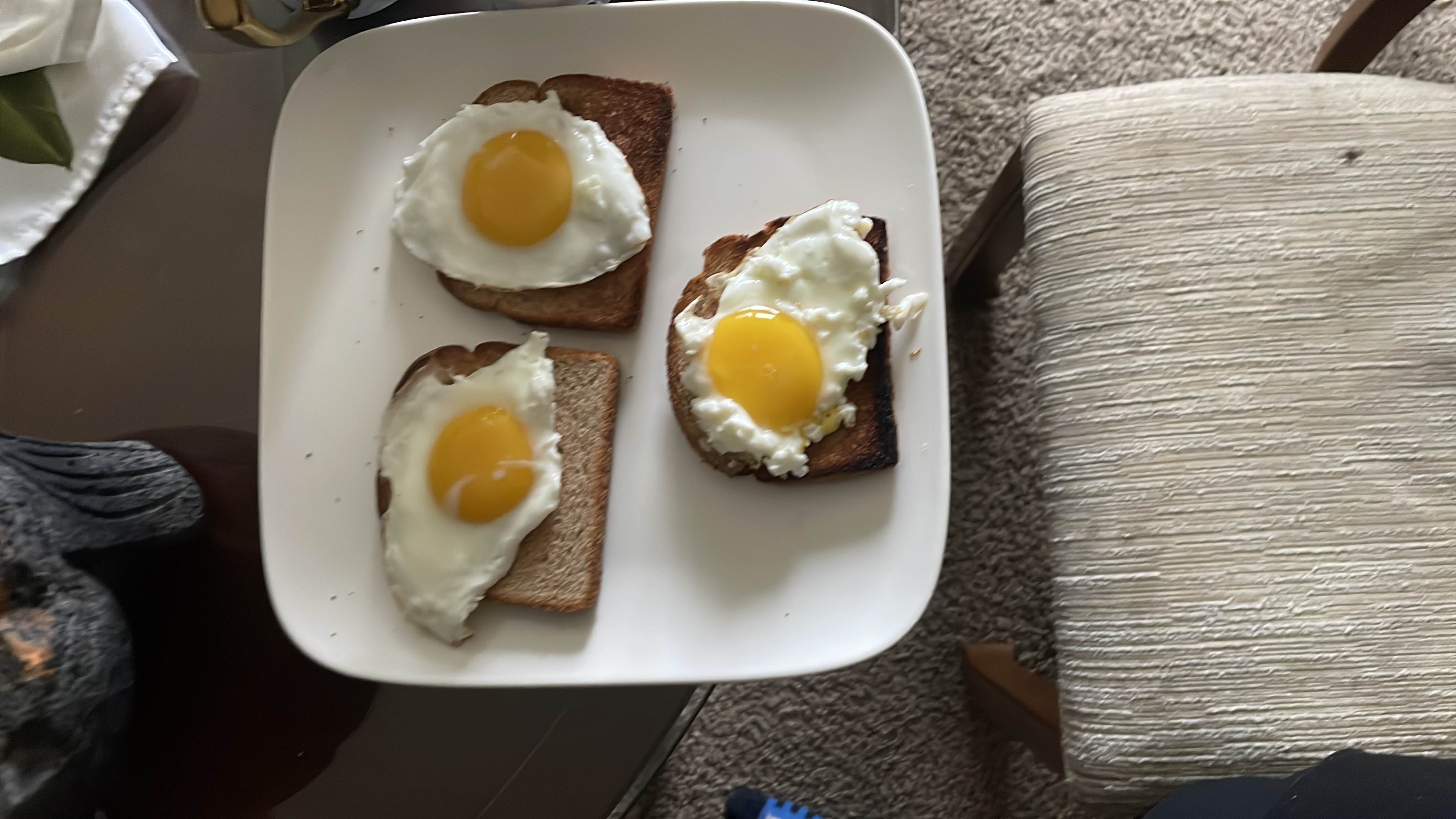 A meal consisting of three slices of toasted bread topped with fried eggs, providing a balanced mix of protein, carbohydrates, and fats.